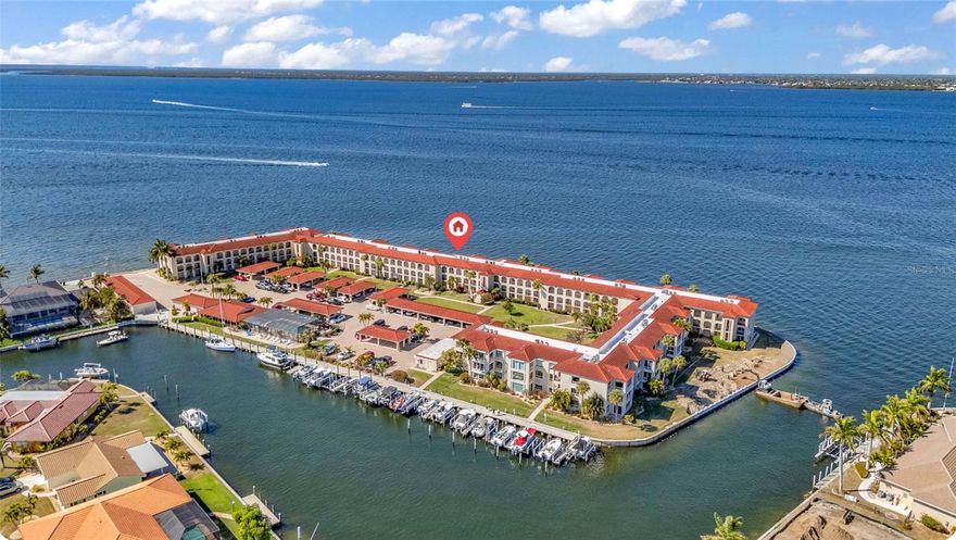 Sweeping, unobstructed views of Charlotte Harbor take center stage in this furnished top-floor 2-bedroom, 2-bath condo. The moment you step inside, your eyes are drawn straight through the living space to sparkling water that stretches for miles, framed by expansive windows and sliding doors capturing boats, wildlife, and unforgettable sunsets. Luxury plank flooring and ceramic tile flow throughout, creating a clean, cohesive look that complements the coastal setting. The kitchen features Corian countertops, solid wood cabinetry with convenient pull-out shelving, illuminated glass-front cabinets, a subway tile backsplash, under-cabinet lighting, and an open layout that keeps the harbor view in sight from the kitchen, dining, and living areas. The fully enclosed Florida room, accessible from both the living room and the primary suite, is surrounded by glass with hurricane-rated windows and includes roll-down shades for added comfort and privacy while you take in the panoramic water views. Both bedrooms are generously sized, with the guest bath offering a single-sink vanity and a tub-and-shower combination accessible from the hallway and guest bedroom, while the primary suite enjoys stunning harbor views and an ensuite bath with a glass-enclosed shower. Major updates include a hot water heater replaced in 2023 and an HVAC system replaced in 2020. The Milestone Report and Structural Integrity Reserve Study have both been completed, and no assessments are planned. Additional highlights include a dedicated laundry room with storage, a second entry with a built-in mail slot, and an assigned covered parking space. Colony Point offers excellent amenities, including a heated pool, activity room, guest parking, boat slips available on a first-come, first-served basis, and a kayak launch for easy access to the water. The building is well maintained with a 50-year stone-coated steel roof and fully funded reserves. All this is just minutes from Fishermen’s Village, waterfront parks, boutique shopping, and restaurants with easy access to US 41 and I-75 for trips to Sarasota or Fort Myers. Be sure to view the attached video to fully appreciate the condo and its incredible waterfront setting. Schedule your private showing today.