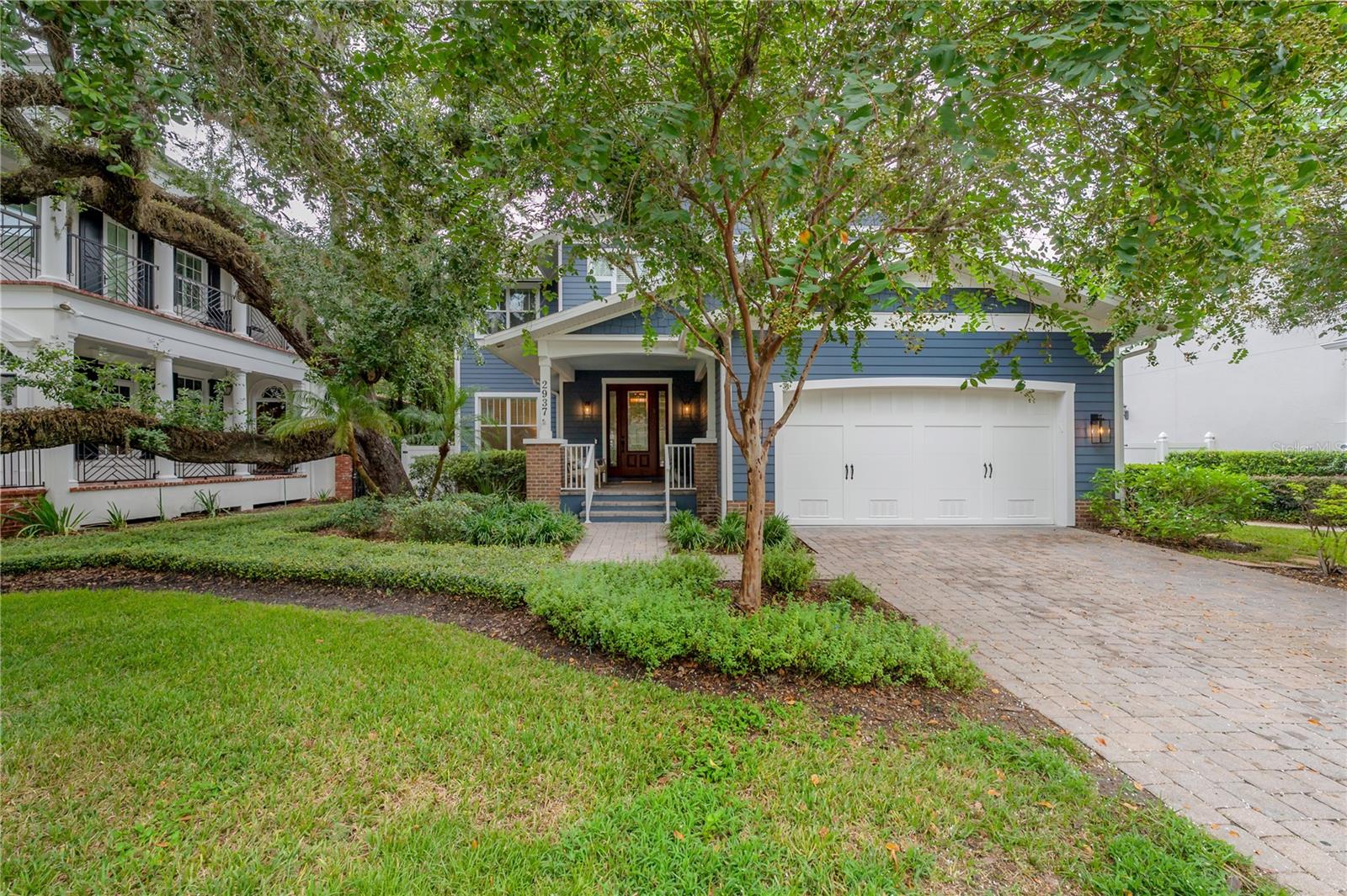 This Craftsman-style gem sits gracefully on one of the most picturesque streets in Bayshore Beautiful. A custom Javic construction build, this home balances everyday comfort with refined sophistication.
A welcoming front porch invites you inside, where you’ll find soaring ceilings, freshly painted interiors, crown molding, and rich engineered hardwood floors. To the left, natural light floods the formal dining room — an elegant space for entertaining. To the right, a custom dry bar leads to the expansive kitchen, where abundant cabinetry, a large walk-in pantry, stainless steel appliances, wine fridge, and gas cooktop cater to every culinary need. A generous island anchors the space, perfect for gatherings, while the open layout flows seamlessly into the dining area and out to the backyard oasis. The screened lanai is an entertainer’s dream, featuring a heated saltwater pool and spa, lush tropical landscaping, and low-maintenance turf that make it both private and practical.
Back inside, the spacious family room with custom built-ins offers a comfortable retreat. Upstairs, the primary suite is joined by three additional bedrooms, two connected by a Jack and Jill bath, and one with its own en suite. In addition to the bedrooms there is an office space. Just a short stroll to iconic Bayshore Boulevard and minutes from downtown Tampa, this home delivers the perfect blend of style, functionality, and location.