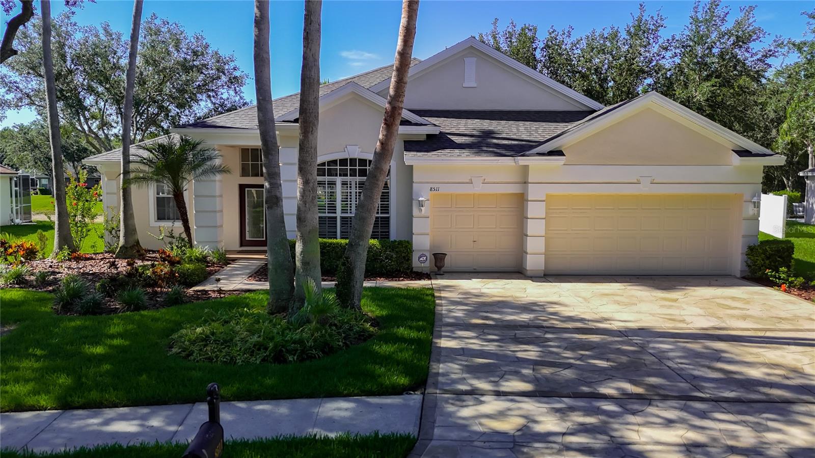Welcome to 8511 Portage Avenue, a beautifully updated 4 bedroom, 4 bathroom single-family home with a spacious 3-car garage, located in the sought-after Richmond Place community of New Tampa. Offering 2,945 square feet of living space on a quarter acre lot, this property combines comfort, style, and convenience in one exceptional package. Step inside and you’re greeted by soaring 12-foot ceilings, an abundance of natural light, and a welcoming open concept layout perfect for both everyday living and entertaining. The updated kitchen features a new refrigerator, oven, microwave, dishwasher, food disposal, wine fridge, newly painted cabinets, and a new kitchen sink. Just off the kitchen, the wet bar and formal dining area provide ideal spaces for gatherings. There’s also a dedicated office space and a spacious laundry room to suit modern needs.The primary suite is a true retreat with private access to the pool through sliding glass doors, a large walk-in closet, a garden tub, and an oversized walk-in shower. Throughout the home, there’s no carpet, just clean, durable tile flooring. Additional interior upgrades include new fresh interior paint (2025), plantation shutters, and electric curtains, Roof (2021). The exterior was painted in 2024, and the newer pool screen enclosure was added in 2023.The screened-in pool area offers beautiful pond views and a peaceful place to relax or entertain. Located in a non-flood zone and just minutes from top rated schools, I-75, shopping, and dining, this home offers the best of both lifestyle and location. Richmond Place features outstanding amenities including a swimming pool, cabana, playground, barbecue area, and tennis/pickleball courts. Don’t miss your opportunity to own a move-in ready home in one of Tampa’s most desirable neighborhoods. Schedule your private showing today.