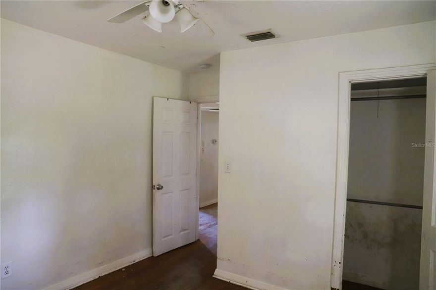 Investor Special _ Prime Rehab Opportunity in the Heart of Hawthorne! This solid built concrete block home is bursting with potential and ready for your vision! Ideally located directly across from the local schools and just minutes from US 301, this property offers convenience and a great foundation for transformation. Inside, you'll find original hardwood floors, a spacious family room, and even a safe room for added peace of mind. The layout includes a front-attached one-car garage, a rear carport, and a generous yard perfect for kids or future landscaping upgrades. Yes, it needs work-but the bones are good, and the opportunities are even better. Whether you're looking to rehab & resell or hold as a long-term investment, this is a fantastic chance to build equity in a growing area. Don't miss out-come see the potential for yourself!