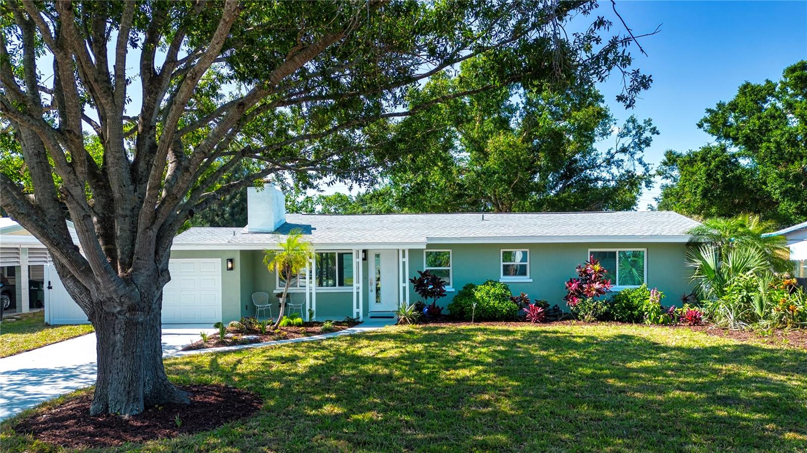 One or more photo(s) has been virtually staged. BACK ON THE MARKET WITH A SIGNIFICANT PRICE REDUCTION!!! Don't let the modest exterior fool you...the drama is inside!! This mid-century home has been completely updated both inside and out! As you enter the home, you are met with soaring cathedral ceilings with exposed beams. The spacious kitchen has been completely updated with sleek modern cabinets, backsplash and quartz counters. The large bar is the perfect spot for the family to gather. The mid century architecture continues with gleaming terrazzo floors, a cool wood-burning fireplace and built-ins in one of the two living areas. A family room addition provides plenty of casual living space as well as easy access to the large private back yard (room for a pool). This home has been made hurricane ready with NEW ROOF WITH EXTRA HURRICANE STRAPS, NEW IMPACT RESISTANCE WINDOWS AND DOORS, TWO NEW AC SYSTEMS, EXTRA ATTIC INSULATION and a SECURITY SYSTEM. Plumbing and electric upgraded in 2014... Walk to Southside School and Brookside Middle School, bike to the beach while enjoying easy access to downtown restaurants and shops.