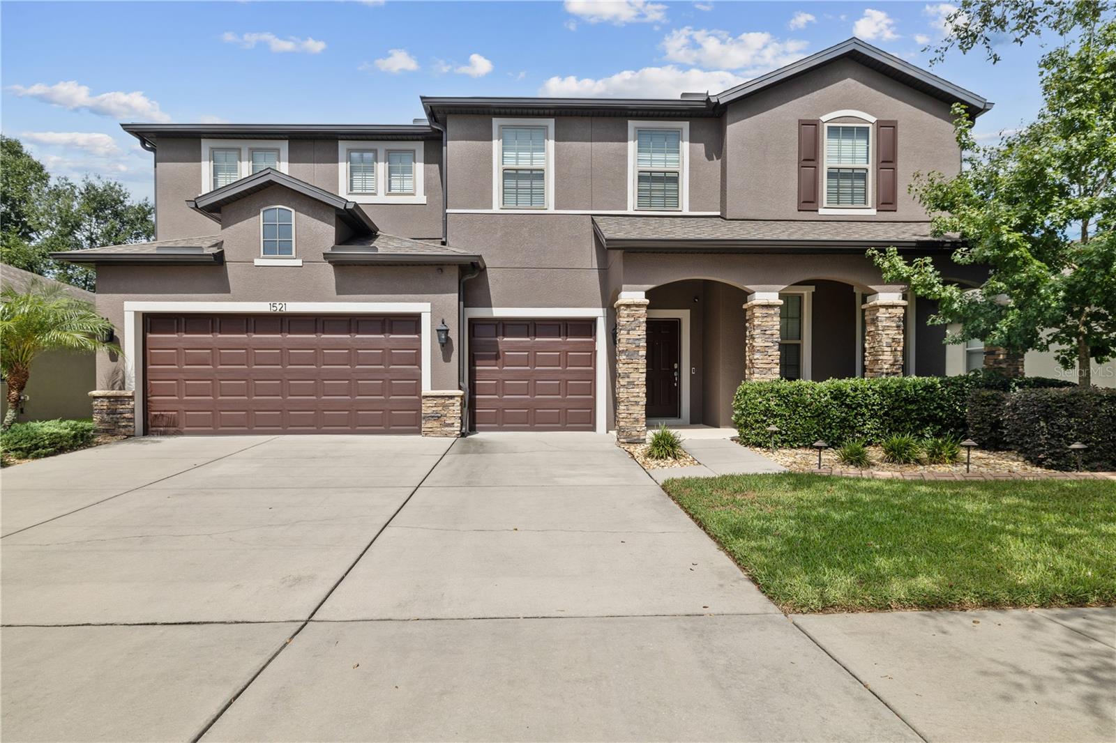 Welcome to the most affordable five-bedroom home currently available within 10 miles!
Spread out in over 4,000 square feet of interior living space, featuring three and a half bathrooms, a spacious open-plan living/dining/kitchen area, an additional family/game room, and more.
The chef’s kitchen includes stainless steel appliances, granite countertops, an oversized island with seating for four, and two walk-in pantries.
An informal dining area separates the kitchen from the spacious living room, which features two sliding glass doors leading to the screened paver porch—one a triple-panel slider that retracts fully, seamlessly blending indoor and outdoor spaces during cooler weather or when hosting guests.
The main level also includes a formal living room, a half bath, a spacious mudroom, and a laundry/utility room.
Upstairs, double doors open to the spacious primary suite, featuring a tray ceiling, a double-sided walk-in closet, and a large bathroom with an extra-long double vanity, a glass-enclosed shower, a private toilet area, and three additional linen/storage closets.
The bonus family/game room, also upstairs, provides easy access to four guest bedrooms and two guest bathrooms.
Both upstairs bathrooms are large and feature a spacious vanity separated from the shower/tub and toilet.
Three guest bedrooms include walk-in closets, and two additional upstairs walk-in closets provide ample climate-controlled storage.
The three-car garage provides the necessary storage for vehicles, equipment, and tools, with the single-door bay easily convertible to a climate-controlled gym, office, or additional living space.
With storms in mind, the current owner upgraded the exterior electrical panel for direct generator hookup, enabling easy powering of nearly the entire home.
Additional updates made in 2024 include new 25-year exterior paint, a water heater, a water softener, and front landscape lighting.
The Highlands Reserve neighborhood is conveniently located less than 10 minutes from grocery stores, restaurants, and other retail services; 12 minutes from Brandon Hospital; and 30 minutes from Tampa International Airport.