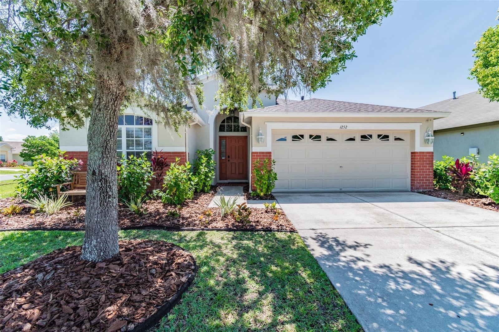 Welcome home to this beautiful 4 bed 2 bath home in Meadow Point III!!! This home has a lot of natural light all throughout the day. The kitchen has stainless steel appliances and a gas stove. The large island is perfect for entertaining or just sitting and relaxing. The master bedroom is spacious and has 2 walk-in closets. The master bathroom has a garden tub as well as a tiled shower. The other two bedrooms have ample space and large closets. High ceilings and an open concept throughout makes this home feel airy. Large sliding glass doors open to a very spacious screened lanai that leads out to the fenced in back yard. This home has a newer roof (2020). Community pool as well as tennis and basketball courts. Minutes from Tampa Outlets, HWY 275, The Grove or Wiregrass Commons.