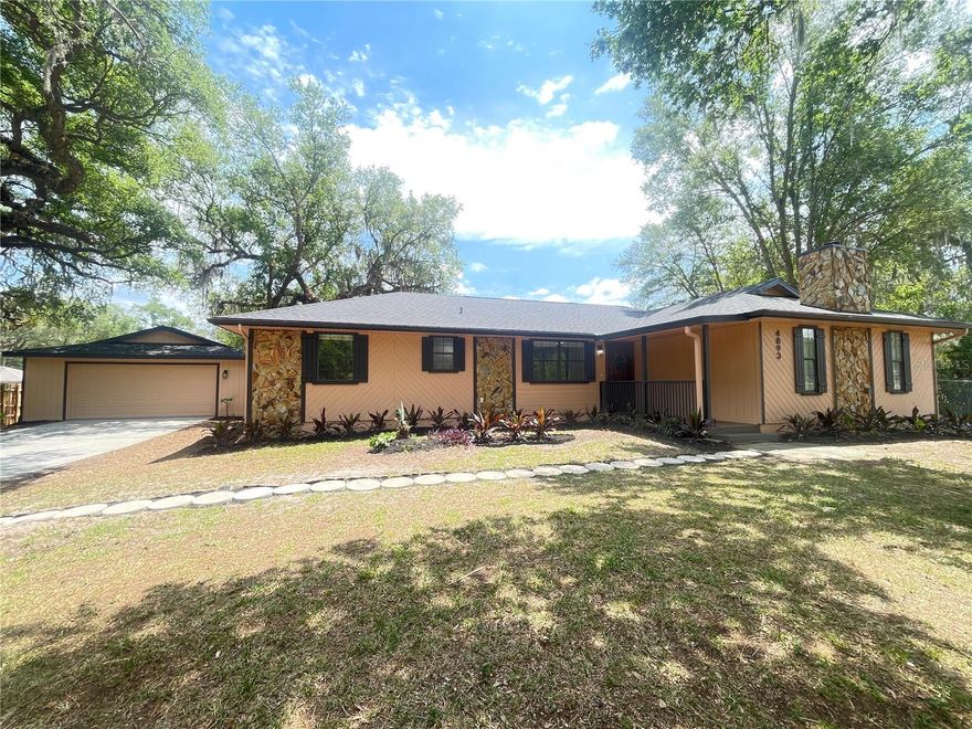 WELCOME TO YOUR DREAM HOME!! This stunning, fully renovated 3-bedroom, 2-bathroom home with a detached 2-car garage- complete with a BRAND-NEW garage door and freshly painted interior and exterior-perfectly blends modern style with cozy charm. Step inside to discover a bright and airy open-concept living space featuring new vinyl flooring throughout and a spacious family room with a beautiful wood burning fireplace. The chef's kitchen showcases new soft-close cabinets, quartz countertops, all-new stainless-steel appliances, and a generous island ideal for meal prep or gathering. The split floor plan was designed with privacy and is complemented by two fully remodeled bathroom. Enjoy peace of mind with significant system updates, including NEW roof (2026), NEW A/C unit (2026), and a NEW water heater. Step outside onto the magnificent breezy back porch overlooking a huge backyard-perfect for entertaining, gardening, or simply relaxing. Conveniently located near shopping, parks, dining, school and medical facilities. Don't miss your chance- Schedule your tour today