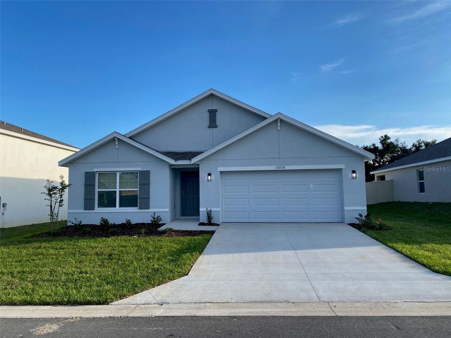 Enjoy this beautiful single-family home located in the desirable and tranquil community of Sunset Hills in Summerfield!! less than 8 miles miles from The Villages. This spacious one-story residence offers 1,828 sq. ft. of living space with 4 bedrooms and 2 full bathrooms, featuring an open-concept layout that seamlessly connects the kitchen, living, and dining areas. The modern kitchen is equipped with stainless steel appliances,  including a refrigerator, dishwasher, range, and microwave, and boasts elegant quartz countertops in both the kitchen and bathrooms. Additional highlights include a two-car garage, a covered lanai perfect for outdoor relaxation, and a laundry room with a full-size washer and dryer. Ideally situated near schools, hospitals, shops, restaurants, and the newly opened Costco, this home offers the perfect blend of comfort, style, and convenience. Don’t miss out on this exceptional opportunity!!!