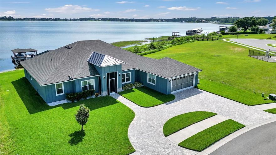 NEW Seller Incentive - Seller is offering up to $22,500 towards Buyer's Rate BuyDown/Closing Cost/Expenses, and this home is priced just under appraisal value --So you can purchase with Equity! 

Contemporary Lakefront Living on Private Lake Arietta

Built in 2023 and designed with intention, this exceptional 5-bedroom, 3-bath lakefront residence offers over 3,200 square feet of refined living on one of Auburndale’s most sought-after private lakes. From the moment you step inside, the home feels bright, open, and effortlessly welcoming—where thoughtful design meets everyday livability.

The open-concept layout creates a natural flow between the main living spaces and the gourmet kitchen, making it equally suited for relaxed daily living and elevated entertaining. Quartz countertops throughout the kitchen and baths add clean, modern sophistication, while floor-to-ceiling tile in every bathroom delivers a cohesive, spa-inspired aesthetic.

What truly sets this home apart is the view. Expansive glass doors frame the water from the main living area, opening to a thoughtfully designed screened lanai that preserves uninterrupted sightlines. From the living room, your eye carries seamlessly across the infinity pool and out to the calm waters of Lake Arietta—blending indoor and outdoor living into one continuous, light-filled experience.

The primary suite is a serene retreat, offering generous space, three closets for exceptional storage, and a luxurious ensuite featuring a standalone soaking tub and an elegant tiled shower. Additional bedrooms are well-proportioned and versatile, ideal for guests, home offices, or multi-generational living.

Outside, the home transforms into a true Florida lakefront escape. An extended covered patio and full outdoor kitchen create an inviting setting for gatherings, while the infinity pool overlooks the lake and is enclosed for year-round enjoyment. A private dock with a boat lift and a jet ski dock provides effortless access to boating, fishing, and sunset cruises on the water.

Additional highlights include a whole-home generator for peace of mind and the advantages of newer construction—modern systems, contemporary finishes, and minimal maintenance—all within a well-maintained community.

This is more than a home—it’s a lifestyle defined by waterfront views, open spaces, and effortless luxury. Schedule your private showing and experience modern lakefront living at its finest on Lake Arietta.