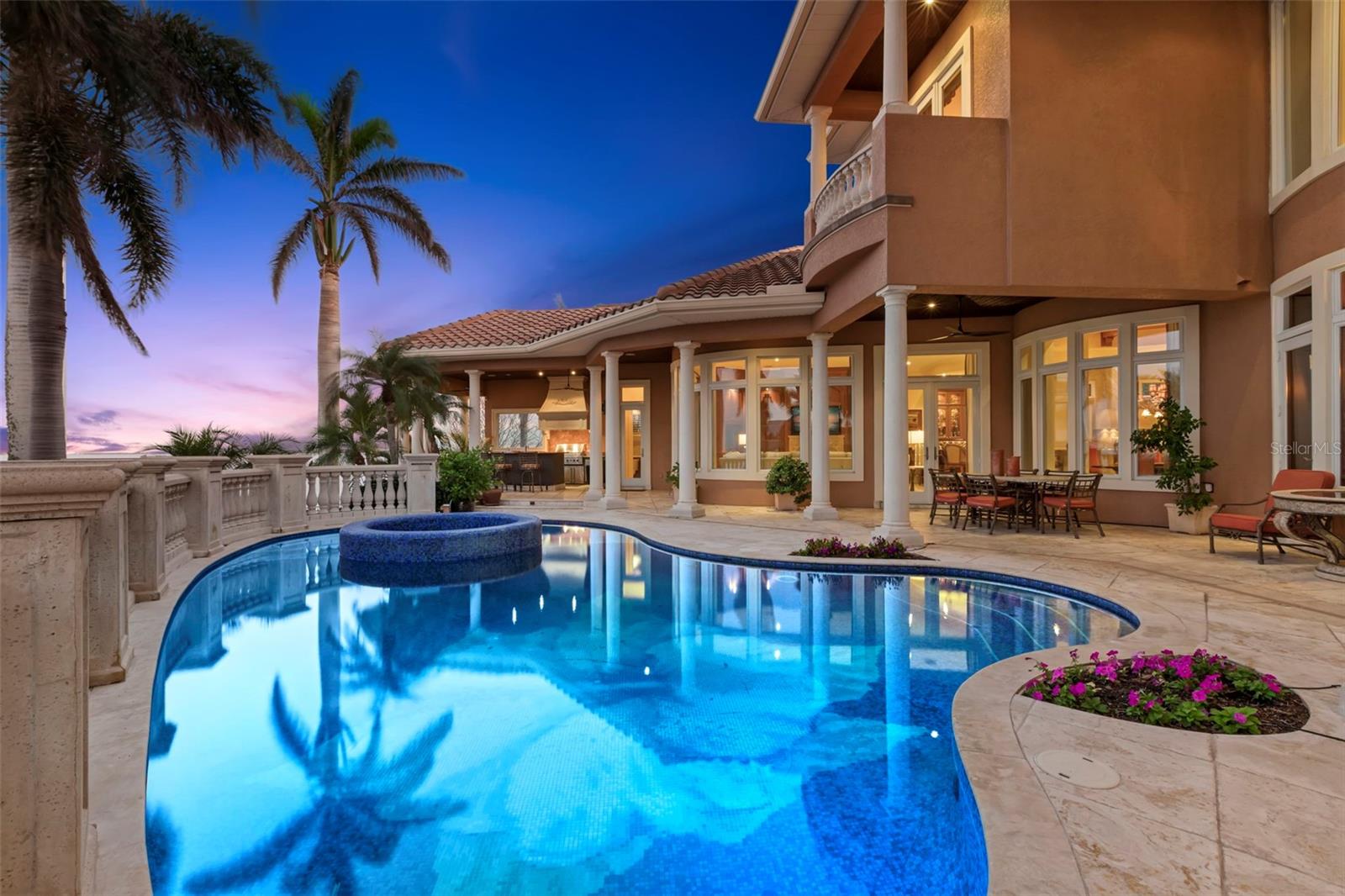 Prepare to be captivated by this extraordinary waterfront residence, custom built in 2006 by the renowned Alvarez Custom Homes. Perfectly poised on a coveted point lot with 185 feet of pristine waterfront, this architectural marvel offers expansive open water views of Tampa Bay and a sheltered haven ideal for docking even the most substantial yachts. As you step through the grand entrance, breathtaking open water views greet you as does the magnificent two-story library, adorned with exquisite mahogany millwork and a gas fireplace framed by onyx, sets the tone for the home's exceptional attention to detail and sophisticated design.
Designed with entertaining in mind, the home's layout flows seamlessly. The chef's kitchen is a culinary haven, featuring top-of-the-line appliances: two dishwashers, two warming drawers, two ovens, a six-burner stove with a grill, a Sub-Zero refrigerator, a separate freezer, a walk-in pantry, a butler's pantry, and a wet bar equipped with wine refrigeration and an ice maker. Every detail has been meticulously planned for effortless hosting and dining.
The spacious first-floor primary suite is the epitome of luxury, boasting an opulent en-suite bath with spectacular venetian plaster and faux finishes, separate vanities, custom-built millwork, and two expansive walk-in closets with custom systems. A dressing area and morning kitchen complete this serene retreat.
Throughout the home, you'll discover a wealth of exquisite details: intricate millwork, elegant moldings, travertine and cherry hardwood floors, and more. The outdoor entertaining spaces are spectacular, featuring a Viking kitchen with a gourmet grill/rotisserie/searing element, side burners, smoker oven, kegerator, ice maker, refrigerator, and bartender server area. The custom glass tile pool and spa, with water fountain features and a shallow sun deck, provide the perfect backdrop for relaxation. For the captain of the family, the side dock offers a haven for multiple vessels, and a yacht while allowing you to still savor the panoramic open water views. Ascend the sweeping marble staircase with custom wrought iron railings to find a gorgeous loft office with built-in features and three spacious bedrooms, including a guest suite with an en-suite bath. Every corner of this home exudes quality and sophistication, inviting you to experience the ultimate in waterfront living. Tierra Verde is a Florida island paradise that offers everything for an outdoor enthusiast as well as convenience to shopping, restaurants, downtown St Petersburg and a quick 30 minute commute to Tampa International. You deserve to have it all!