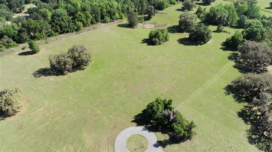 Via Paradisus - 10.01 +/- Acres of beautiful Ocala equestrian land graced with magnificent Granddaddy Oaks. This lot is located on cul-de-sac for added privacy.  Bring your plans for your dream home or farm. High elevations. Access to the Marjorie Harris Carr Cross Florida Greenway and close to the Florida Horse Park. Deed restricted to 10+ acre home sites. Horses welcome! Florida's Marjorie Harris Carr Cross Florida Greenway is by far one of the most treasured natural resource available. Via Paradisus enjoy two private entrances.