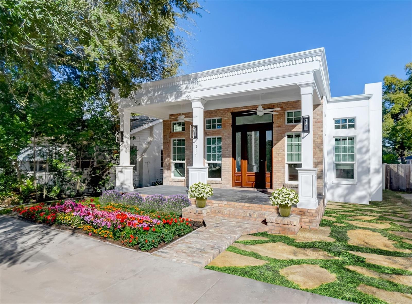 One or more photo(s) has been virtually staged. Gorgeous, Newly Renovated, Custom Designed New Orleans Style Turn of The Century Classical 3/2 Home Located in NE St Pete, just 2 Blocks from Crescent Lake Park!!! Stately columns with coach lights line the large front porch that is tiled in elegant tiles setting the stage for this magnificent home!!! Be prepared to be wowed as you enter the home through the impressive, tall, custom solid mahogany entrance door to the spacious, sunny & bright, open concept living area with soaring 11'4" high, intricately designed, coffered ceilings with in-set led color changing lighting that is controlled through an app and an electric fireplace for ambiance. The home features wide custom crown moldings, 7 1/4" baseboards, 8' solid core interior doors, walnut wood look luxury vinyl flooring, custom lighting, tall hurricane impact windows with transoms & custom window treatments throughout!!! The state of the art kitchen is an entertainer & chef's delight with an island, custom two tone cabinets with soft close drawers & doors, quartz countertops, pendant & recessed lighting, a 48" gas stove with 6 burners, a griddle, double convection ovens, instant hot pot filler & range hood, a full height wine cooler with beverage drawers, a French style 3 drawer fridge and a butler's pantry with washer & dryer!!! The kitchen has french doors opening to a large, tiled back deck that has a gas line for a grill and plenty of room for an outside dining space!!! The master suite also has a custom designed coffered ceiling with mood setting, led color changing lighting, a custom, walk-in closet, french doors opening to the back patio and a luxurious, spacious en-suite with beautiful marble flooring, double vanities & a large open shower with a rain shower head, massage jets & a soaking tub that is the perfect place to relax & unwind after a long day! The second & third bedrooms are sunny & bright both with spacious, custom closets!!! The glamorous guest/hall bath is a stunner with an antique style vanity with a marble top and vessel sink, designer mirror & lighting, marble flooring, a large shower with a rain shower head, massager jets, black marble deco style floor tile with gold grout and seamless glass enclosure!!! The home has an oversized 1 car garage and will have a 1 car carport on the left side of the garage that is accessed via the alley behind the home. This amazing home is just a few weeks away from being completed!!! The landscaping in the photos has been virtually staged in a similar design to the landscaping to be installed. CHECK OUT THE INTERACTIVE 3D FLOORPLAN & VIDEO CLIP OF THIS HOME IN THE VIRTUAL TOUR LINKS!! DON'T LET THIS UNIQUE RENTAL OPPORTUNITY TO RENT A TOTALLY REDESIGNED, NEWLY RENOVATED CUSTOM HOME SLIP BY!!! CALL TODAY TO BOOK A PRIVATE SHOWING!!!