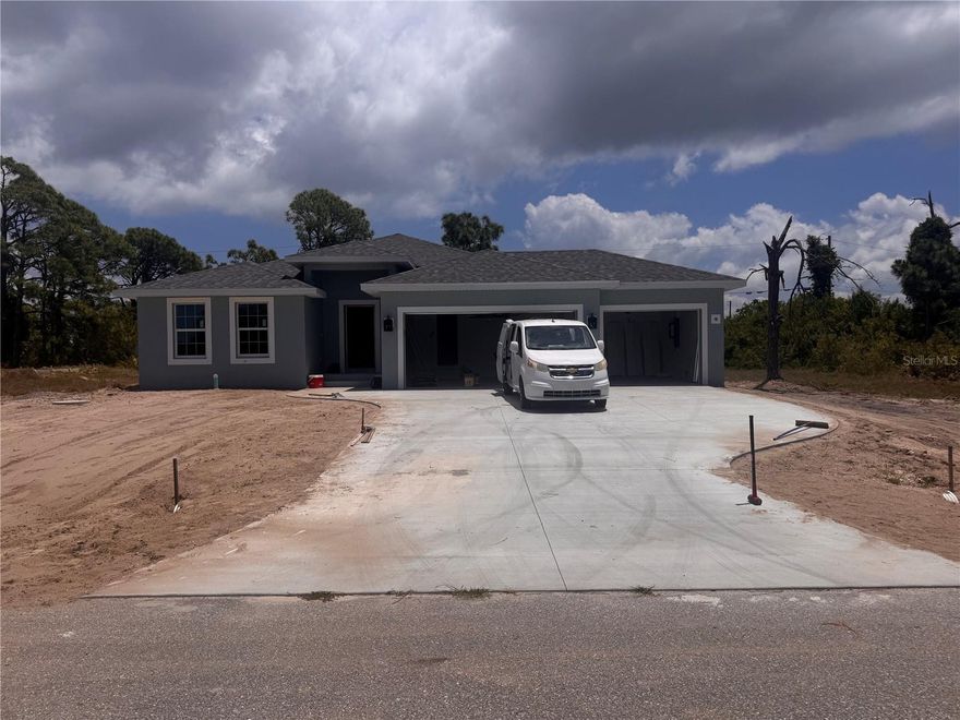 Under Construction. X FLOOD ZONE !!!! Our SGC 1 Model features an open floor plan from the minute you walk in the door. This home as 1663 sq foot of Living Space, 3 bedrooms, 2 baths and 3 Car Garage. The open kitchen is perfect for entertaining, includes a spacious island, breakfast/dining area, and doors leading to the lanai to enjoy your morning coffee. The master bedroom includes a walk-in closet, Tiled shower, and Dual sink vanity. The 2 Guest bedrooms are located on opposite side of Master making it a split floor plan. Guest bathroom has a tiled shower/tub combo. The living room features cathedral ceilings. The home features plank tile throughout, granite countertops in the kitchen and bathrooms, recessed lighting, ceiling fans in every room, and Stainless Steel Appliances. The home comes with hurricane/storm shutters. COME VIEW THIS BEAUTIFUL HOME or CALL TODAY FOR AN UPDATED LIST OF OUR BUILDS! PLEASE NOTE - the pictures for this listing are representative of the subject home being constructed. Interior and exterior paint colors, shingle colors, tray ceilings, fans, lights, manufacturer of appliances, interior/cabinet door style, and landscaping are subject to change.