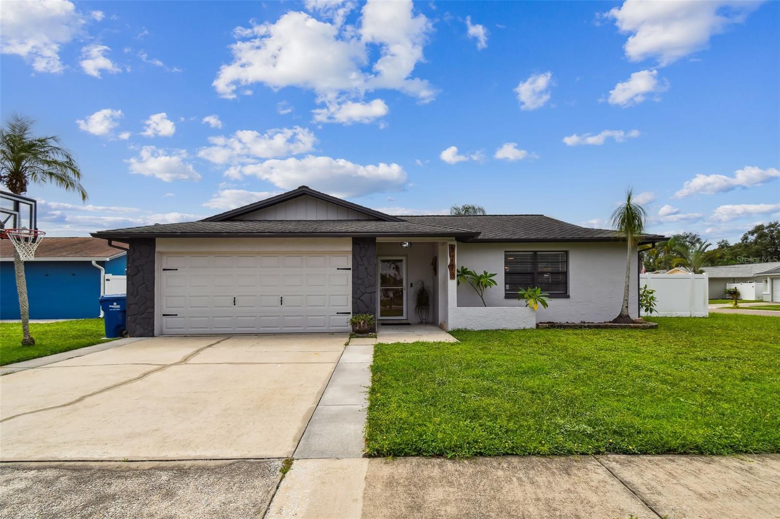 What you've been looking for! Location, Condition, Value- an excellent residence in the sought-after Blue Water Cove community. There were no flooding issues here with the 2024 storms and there are no HOA fees. This three bedroom, two bath corner lot home has been lovingly updated and has spacious outdoor spaces for relaxing and entertaining. Location is an easy drive to the sparkling sands of the Gulf beaches, Tampa, shopping and dining. Walk to the canal and drop in a hook and try your luck or pull your boat out from the backyard covered storage and head to Gulf. Your open kitchen, with breakfast bar has French door refrigerator, range, microwave and dishwasher. Washer and dryer are just steps away in the garage.