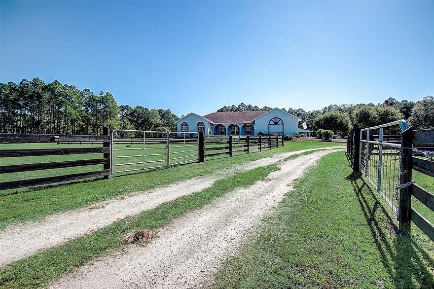 Fall in love with this custom-built 4 bed 2 bath home on 10 acres! The homes gourmet kitchen features dual kitchen sinks, custom cabinetry with under-mount lighting and slide-out drawers, and stainless steel appliances. Relax in the master suite oasis complete with dual vanities, walk-in closet, and a separate walk-in shower. Low maintenance tile flooring throughout the living space as well as plantation shutters on the windows. Home has been painted inside and out and features a new A/C unit, New tankless water heater, two separate water wells with a water softening system, central vac system, and a whole home Generac system with a 500 gallon buried gas tank. Spend fall nights out on the private back patio taking in the picturesque scenery! This home is perfect for a horse lover with a large 36x36 barn featuring 3 stalls, a tack room, and a spacious cross-post fenced in yard! Located riding distance to Wiregrass Prarie Preserve and Deep Creek Preserve. You don't want to miss out on this great home!