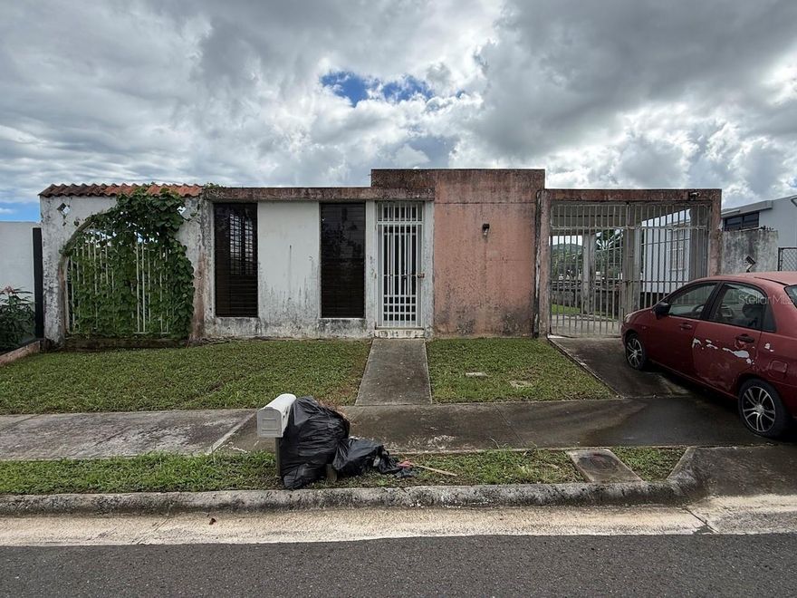 Under contract-accepting backup offers. Start 2026 by purchasing your property. An excellent opportunity, whether for your first home or an investment property. It has 780 sf GLA on a 350 sm lot. Good size front and back yard, ideal for a terrace and a swimming pool. Property offers wide laterals spaces for cars and water sports vehicles. One-car open garage. Annual Property Tax  $827.43 (approx., not presently exempted). FEMA Zone: X (low or average) and Zonning: R-I (Intermediate Residential). It is located approximately 2.5 miles from the PR-3 highway and 3.7 miles from Plaza Fajardo Mall, with convenient access to shops and essential services. Sold in its current condition (“as is”). Repairs and upgrades needed.