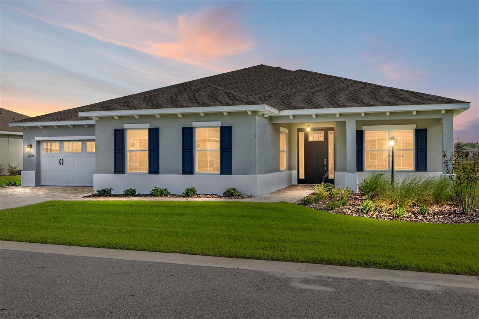 Welcome to the Magnolia Model, a beautifully designed new construction home in LongLeaf Ridge at On Top of the World, Ocala’s premier 55+ active adult community. This home offers 2 bedrooms, 2.5 bathrooms, a 2-car garage with separate golf cart parking, and wood-like tile flooring throughout, complemented by a paver driveway and walkway. Elegant tray ceilings and crown molding enhances the living areas, adding a touch of sophistication. The gourmet kitchen is a chef’s dream, featuring staggered brown cabinetry, a huge island with additional storage cabinets, quartz countertops, built-in oven and microwave, 5-burner cooktop with range hood, walk-in pantry, and an elegant, tiled backsplash—perfect for entertaining or everyday cooking. The dining area is bright and inviting, with four floor-to-ceiling windows overlooking the backyard, while the living area opens through a 4-panel sliding door to the screened lanai, ideal for indoor-outdoor living. The primary suite is a private retreat with a tray ceiling, 3-panel window with blinds overlooking the backyard, a generous walk-in closet, and a spa-inspired en suite featuring a zero-entry tiled shower with built-in bench, double vanity sinks with quartz counters, and a linen closet. With its open layout, elegant finishes, and access to world-class amenities in a gated, golf cart-friendly community, the Magnolia model perfectly combines comfort and style. Schedule your private showing today and experience the luxury of On Top of the World living!