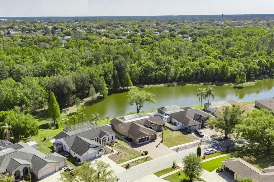 ENJOY ONE OF THE BEST VIEWS IN RIVERVIEW from your private pool lanai overlooking a woodsy pond on 2/3 acre! This customized and upgraded home has a coveted spot at the back of no-fee Boyette Springs, yet it's still close to the neighborhood playground park and excellent elementary school. Inside 2,210 SF, the Suarez Rosewood design provides 5 bedrooms, 3 baths, 2 front formal rooms, plus a casual family room that opens to a kitchen with snack bar and windowed breakfast area. Lots of improvements here from the 2018 HVAC and roof to the 2022-23 remodels of the kitchen and primary bathroom. You'll find quartz and granite counters in those rooms as well as quartz in both other bathrooms, stainless-steel appliances, fresh paint inside and out, etc. Sliders open to the large, screened pool with expanded, stone-pavered deck to accommodate extra seating under the roof. It's a pool designed for water sports, deeper in the middle than either end, with a pump and saltwater cell new in 2024. The 3-car garage adds a screened door over the 2-bay entry to allow a breeze without bugs, and the pavered driveway complements stacked-stone accents in front for an attractive welcome home. Boyette Springs is convenient to schools, shops, restaurants, recreation destinations and commuter routes. You want to live here!