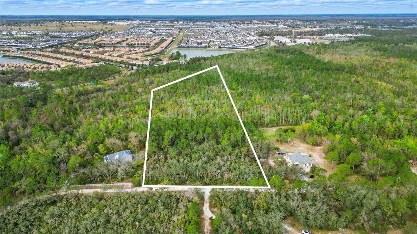 THIS IS THE OPPORTUNITY YOU HAVE BEEN WAITING FOR!! Build your new home on this magnificent 6.38 acre parcel of land that is located on a cul-de-sac within the gated and quaintly named Happy Trails subdivision. This property boasts 1.27 high and dry acres, ideal for your dream home, with zoning (OAE5) that supports a wide range of outdoor activities, including hiking, gardening, and keeping horses and livestock. All residents in Happy Trails own a minimum of 5 acres of land, allowing for ultimate privacy and personal enjoyment. In addition to your single family residence, Happy Trails allows for (3) small one-story accessory buildings which may include a detached private garage and/or guest quarters, barn or stable, and a utility building. This unique gem of a location allows you to live in an environment with large mature trees and a natural habitat, while being so extremely close to city amenities. With a Kissimmee/Celebration zip code, this amazing equestrian community is adjacent to Champions Gate, Reunion and Celebration, and a mere 10-minute drive to Walt Disney World! The central location of the neighborhood has direct access to US27, 192 and I-4 which allows for expedited travel times to restaurants, shopping, schools and all the wonderful things the area offers. Opportunities like this are rare—don’t miss your chance to secure this serene slice of paradise!