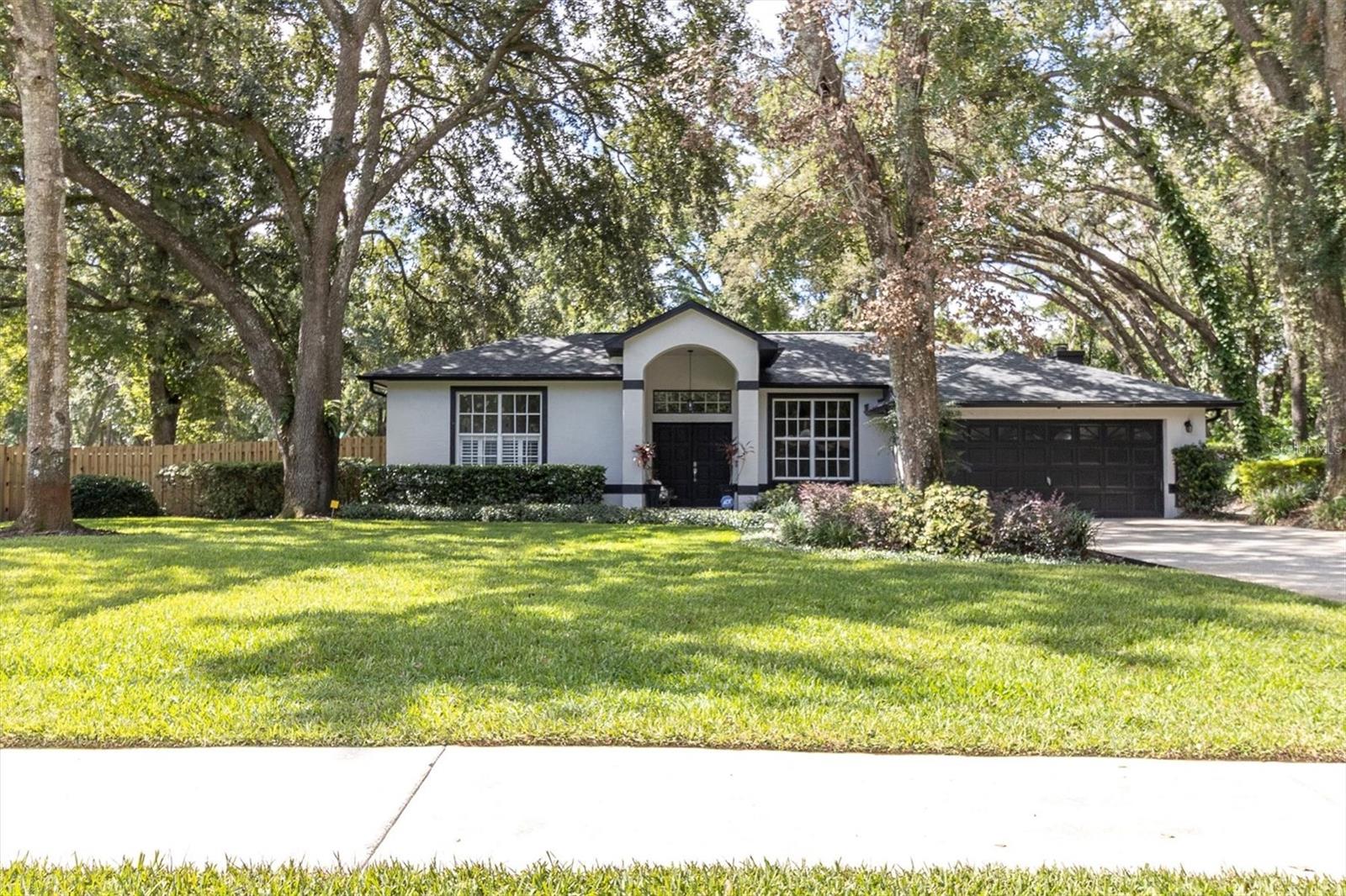 Beautiful 4/2/2 home on just over a half-acre lot! Roof 2022, AC 2016. RV/Boat Parking with a suitable privacy fence for all your toys. Water heater 2025. NEW interior/exterior paint! Wood-burning fireplace! NEW fence! Sprinklers on well! Both baths have been completely updated with quartz countertops. This split floor plan provides the perfect home to spread out. Plenty of room for a pool, and a pool bath already there for it. NEW lanai screen enclosure. Playground equipment is ready for the next family with a mulched-out area just for it. NEW spectic 2022. The primary bedroom has a gorgeous ensuite with an oversized walk-in closet and custom shelving. Plenty of storage in this home. All rooms have fans. Inside laundry. The oversized 2 car garage has epoxy flooring. The driveway is extended, providing ample space for plenty of cars. NO HOA or deed restrictions. Comveniently located to everything you need!