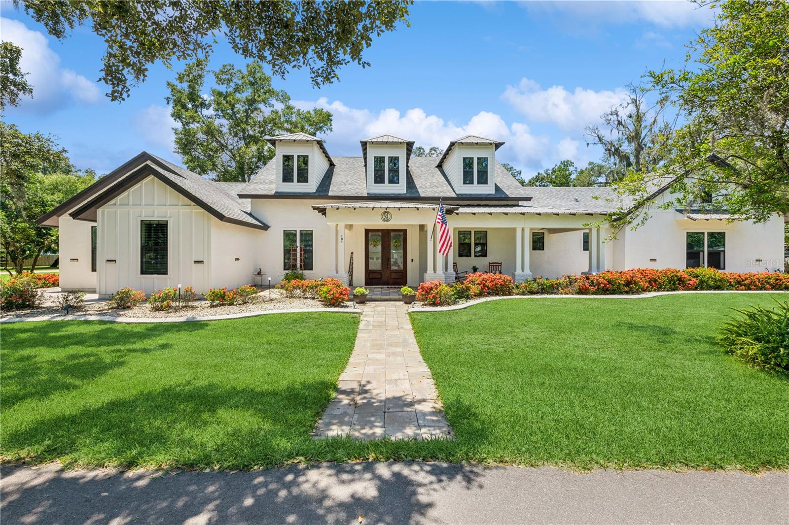 Welcome to 101 N Starr Street, an exceptional single-story, custom-built residence nestled in the heart of historic Oakland, Florida—where timeless craftsmanship, luxurious finishes, and everyday convenience blend effortlessly. Set beneath a canopy of majestic, centuries-old oaks, this meticulously designed home offers a rare combination of elegance, comfort, and accessibility. With a spacious open floor plan, soaring 14-foot ceilings, and oversized 8-foot doors throughout, the home is both grand in scale and thoughtfully functional. Fully handicap accessible and designed with mobility in mind, it offers seamless, barrier-free living that accommodates all stages of life.
At the heart of the home lies a gourmet kitchen, professionally designed by a chef and custom builder. This culinary centerpiece features top-of-the-line appliances, generous prep space, and luxury finishes—perfect for everything from everyday meals to large-scale entertaining. The open-concept design continues into expansive living and dining areas that flow effortlessly into the outdoors, creating an ideal environment for both intimate gatherings and lively celebrations.
Step outside to your own private oasis: a beautifully screened-in pool, complemented by a fully equipped summer kitchen and ample patio space for lounging or dining under the stars. Whether you’re enjoying a quiet morning coffee poolside or hosting a weekend cookout, the outdoor living area is designed to elevate your lifestyle year-round.
Located just steps from the Oakland Farmers Market, Charter School, Heritage Center, and Post Office, this home is at the center of a walkable, welcoming community where neighbors know one another and nature thrives. With direct golf cart access to vibrant Downtown Winter Garden, you’re only minutes from award-winning restaurants, unique shops, live entertainment, and a bustling weekly farmers market. Outdoor enthusiasts will love the nearby West Orange Trail and Lake Apopka’s scenic shoreline, perfect for biking, walking, birdwatching, or kayaking.
And when adventure calls, you’re a short drive from some of the world’s most celebrated destinations, including Walt Disney World, Universal Studios, and Downtown Orlando. Combining small-town charm with big-city convenience, this location is truly second to none.
More than just a residence, 101 N Starr Street is a destination for those seeking refined, accessible living in one of Central Florida’s most desirable communities. With its custom design, premium features, and unbeatable location, this home offers a lifestyle of beauty, comfort, and lasting value.