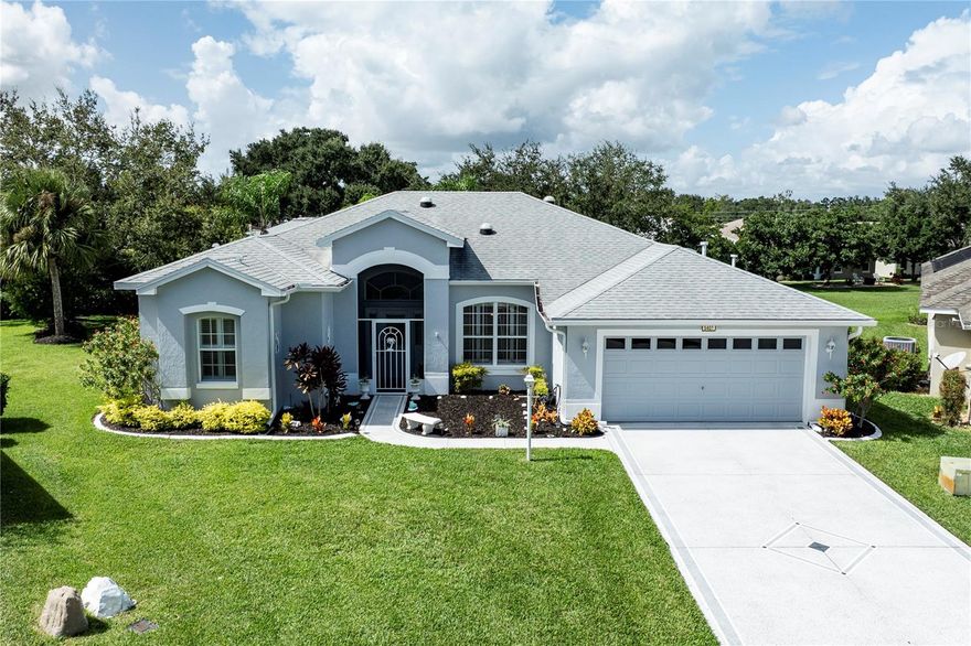 Resort Style Living at its best! This beautiful home is located in the amenity-rich 55+ active adult community of Legacy of Leesburg in Florida, which is centrally located between Clermont and The Villages. This home has an amazing floor plan, many upgrades, and has been meticulously maintained. The home sits on an oversized lot which is approximately 1/4 acre of land on a quiet cul-de-sac. Upon entry to the home, you are welcomed into the formal living/dining space with Vaulted ceilings, arched doorways, and two (2) Solar tubes which brings in the Florida sunshine. The living/dining room opens through French doors to the enclosed 3 seasoned lanai which extends to an outside screened in patio. The primary suite (38x12) is just off the formal living areas and features his and her walk-in closets, a linen closet, a very spacious walk-in shower, dual sinks, many cabinets, and a separate water closet. When it is time to entertain, the kitchen is at the heart of the house and boasts 42" cabinets with pull out drawers, a small appliance cabinet, a solar light, Corian countertops, a beautiful tile backsplash, and a breakfast bar that overlooks the family room. The family room has custom built-in bookcases and an engineered hardwood floor. This amazing home has an abundance of features and upgrades - Laminate floors in the 2nd and 3rd bedroom, 10 ft ceilings in family room, kitchen and nook, Crown Molding in primary bedroom, kitchen and family room, Plantation shutters throughout except for 2nd and 3rd bedrooms, Built in cabinets in Laundry room, solar tubes/ceiling lights (4) in living/dining room, kitchen, lanai, Colored Cut glass chandeliers in entrance foyer and dining area. All new drought tolerant and low maintenance landscaping done (2023), Cement curbing around the house painted and sealed (2023), Irrigation system with metered sprinklers updated(2023), Entire interior of home was painted including the closets, lanai, and garage(2022), Guest Bathroom remodeled and shower doors added (2022), New carpet in lanai (2022), Additional shelving in all closets added (2022), Ceiling fans replaced in 2nd and 3rd bedroom (2022), Epoxy coating in garage, driveway and walkway leading to the front entrance (2019) , Exterior painting of home (2019), Whole house water filtration system added (2017), REFRIGERATOR WITH ICE MAKER (2018), HVAC (HEAT CYCLE IS POWERED BY NATURAL GAS) (2018), NEW ROOF (2019), GASWATER HEATER (2022). The Community features a gated entrance and is perfect for those looking for an Active Adult Community. Legacy of Leesburg offers an abundance of activities. The Clubhouse has a Fitness Center, Aerobics, Dance Studio, Hobby, Game Room, Card Room, Ceramics Studio, Arts & Crafts Studio, Sewing Studio, Ballroom, Computers, Library, Billiards, Demonstration Kitchen, and Locker rooms. Outside there is a beautiful Resort style swimming pool, many Walking and Biking Trails (17), Tennis Courts, Pickleball Courts, Bocce Ball Courts, Horseshoe Pits, Softball/Baseball Field, Picnic area, and a Gazebo. Legacy of Leesburg is known as the Nature community and has preserved many Scenic Lakes, Ponds, Parks and Natural Space. HOA fee includes an RV/Boat secured parking lot, cable and internet. All information recorded in the MLS is intended to be accurate however, it should be independently verified by buyer and their agent. Check out the Virtual Tour Video!