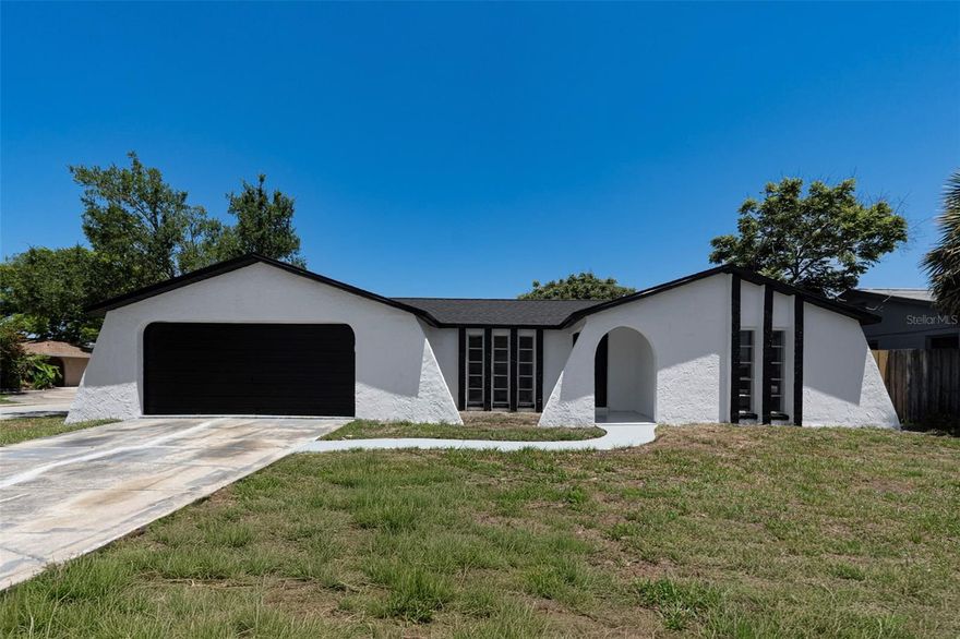 Beautifully remodeled block home with a NEW 2026 roof and move-in ready! This stunning property features an open-concept floor plan, luxury vinyl plank flooring throughout, quartz countertops, shaker cabinetry, stainless steel appliances, recessed lighting, and modern designer finishes. Situated on a spacious corner lot, the home offers a functional layout with generously sized bedrooms and plenty of natural light. Enjoy Florida living from the large covered lanai overlooking the fully fenced backyard with a brand-new fence, providing privacy and ample space for entertaining, pets, or outdoor activities. Complete with a 2-car garage and conveniently located near shopping, dining, parks, medical facilities, and the beautiful Gulf Coast beaches. A must-see!