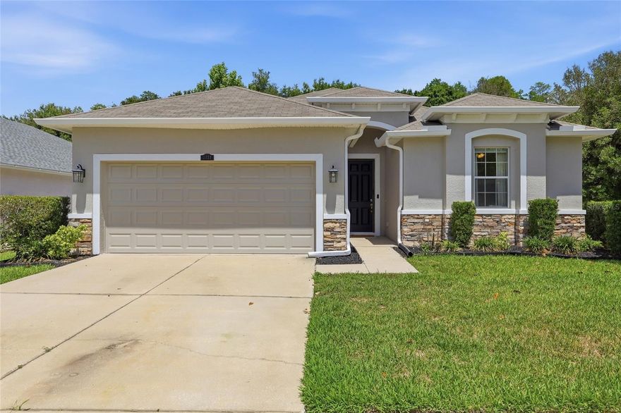 LOW HOA, NO CDD, fresh exterior paint, and a desirable split floor plan in the heart of Wesley Chapel! This 4 bedroom, 3 bathroom home in Ashton Oaks sits on a corner lot at the beginning of a cul-de-sac with peaceful conservation views, a white vinyl fenced backyard, and room to relax, entertain, and enjoy Florida living. Inside the home, decorative wood accents including board and batten and panel molding add character and elevate the rooms. Luxury vinyl plank flooring runs throughout the home with tile in the bathrooms for easy maintenance and style. The thoughtfully designed layout includes a guest bedroom tucked away at the back of the home with its own ensuite bathroom, making it ideal for guests, multigenerational living, or even a future pool bath setup.The laundry room features upper cabinets for additional storage, helping keep everything organized and out of sight. The spacious backyard is complete with a firepit and plenty of room to play. Conveniently located near I-75 with easy access to Wiregrass Mall, Tampa Premium Outlets, hospitals, restaurants, and everyday essentials, this home places you close to everything Wesley Chapel has to offer.