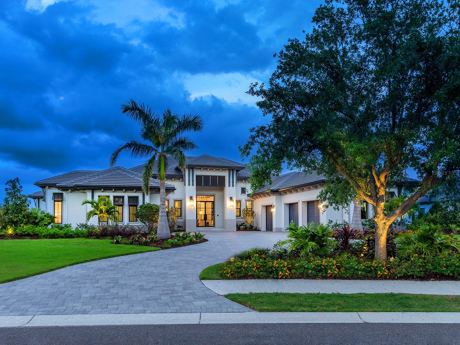 Welcome to this immaculate residence, where every detail has been completely hand-selected and designed for an upscale, contemporary lifestyle within The Lake Club. This 2023 Stock Custom Homes is one of only a few built by this elite branch of Stock construction in the entire neighborhood; and is offered FULLY FURNISHED with designer furnishings curated by SOCO Interiors. This one-of-a-kind floor plan features spaces for every need imaginable, wrapped in warm sophistication, including a separate casita, bonus room, study, gym, and 4-car garage with A/C. Located on over 0.8 acres on a desirable corner lot facing Linear Park, offering a massive side yard with meticulous landscaping; lake views and a conservation area beyond. From the circular driveway you are welcomed home to a modern elevation where double glass impact doors usher you inside where you’ll see the first glimpses of meticulous design that’s present in every room including custom ceilings, wood detailing, elegant lighting and European oak flooring. The great room is the heart of the home and the ideal place to gather around the gas fireplace with stone surround, tray ceiling with custom beams and disappearing corner impact sliding glass doors opening to the lanai. Enjoy breathtaking sunrises from the marble paver lanai with Roman Rock tongue and groove ceilings, classic colonnade screen enclosure, multiple gathering areas, gas fireplace and separate outdoor kitchen and dining space. The sparkling pool with 360 spill edge spa showcase waterfall features, fire bowls, plus a separate lounging area with fire pit overlooking the lake. Additional sliders offer a completely seamless flow between the indoors and lanai living space. The gourmet kitchen has every amenity imaginable with two full islands, custom cabinetry with pots and pans drawers, thick Pompeii quartz counters and backsplash, and hidden storage. This kitchen is the envy of professional chef’s with top-of-the-line appliances including Wolf wall oven, Wolf steam oven, Cove dishwasher, Wolf 6 burner gas range with 2 dual fuel ovens, Subzero 36” refrigerator and 24” freezer, plus a massive walk-in butler’s pantry with plentiful shelving, cabinetry, and Wolf microwave drawer, Fisher & Paykel dishwasher, and JennAir fridge and freezer drawers. Dine in style in the dining room surrounded by sliding glass doors and a custom wine bar. The owner’s wing is outfitted with a study with built-in shelving, peninsula desk with Pompeii quartz, plus French doors leading to the lanai. The primary bedroom is poised for elegant relaxation with custom ceiling, French doors, dual walk-in closets with custom shelving, and spacious spa-like bathroom with modern freestanding tub, thick Pompeii quartz counters, and walk-in shower. The guest suites in the main home exude their own personal luxury with en-suite bathrooms and walk-in closets. The rear bonus room is conveniently located off the lanai and has a full pool bathroom. Don’t forget about the casita with its own private entrance, large living room with kitchenette, full bathroom, and bedroom with French Doors to the lanai. Ingenious upgrades include smart home systems, surround sound, Lutron motorized window treatments, solid pine doors, 20kw generator, impact doors and windows, Kinetico water treatment system with reverse osmosis. The Lake Club is an exclusive premier, gated community with a Grande Clubhouse, restaurant, pool, tennis, pickleball, fitness and more.