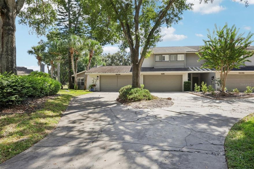 Welcome home to this charming one-story, 3-bedroom, 2-bath townhome tucked into the beloved Carrollwood Village neighborhood. Sit back and soak in scenic views of the golf course right from your screened-in patio—perfect for sipping morning coffee or unwinding after a busy day. Inside, natural light pours through generous windows, illuminating a warm living room centered around a cozy fireplace—ideal for relaxed evenings or catching up with friends. Stunning marble-look tile flooring flows through the living room, giving it an even more upscale look. The kitchen has been thoughtfully refreshed with crisp white cabinetry, neutral granite counters, stainless steel appliances, and plenty of prep space (yes, there’s room for the charcuterie board you keep meaning to make). The primary bedroom offers a peaceful retreat with cozy carpet, and it's complete with an updated en suite and a walk-in shower dressed in tasteful tile. Two additional bedrooms share a full bathroom that’s also been tastefully redone. If you like the idea of combining everyday comfort with scenic views, being just steps from the Carrollwood Country Club and all the local dining, shopping, and recreation, this home really delivers. Let’s plan a showing — come see it for yourself and let the light (and that view) sell you.