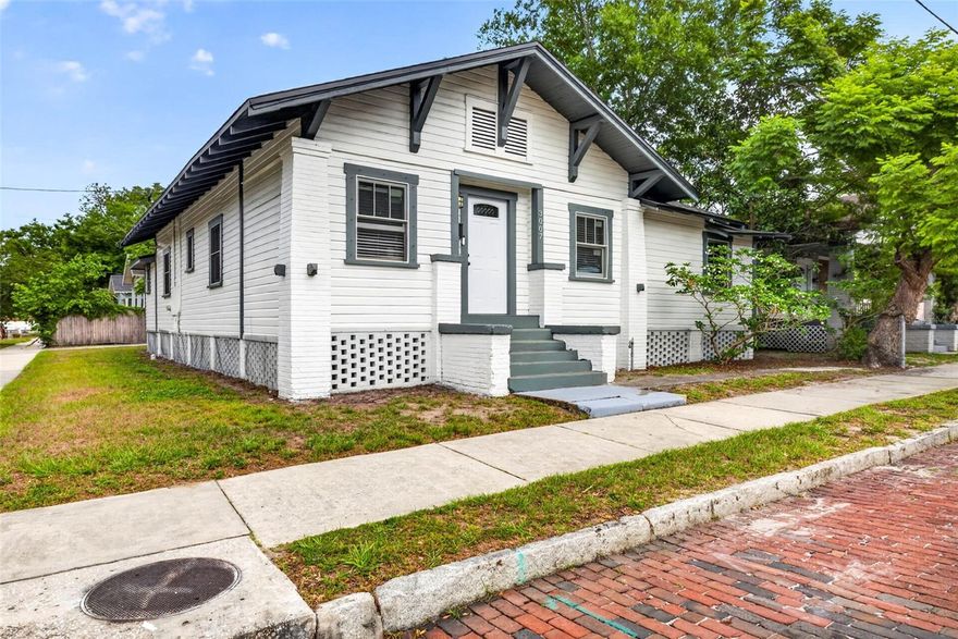 SINGLE FAMILY HOME WITH DETACHED and SEPARATELY ADDRESSED INLAW SUITE -- PERFECT FOR ADDITIONAL LONG OR SHORT TERM RENTAL INCOME and HOUSE HACKING! The Property underwent a FULL REMODEL IN 2018 (Roof, plumbing, electrical systems, double pane windows throughout, and interior finishes) and has been well maintained since. The Remodeled 4-bedroom, 2-bathroom bungalow in the highly desirable Tampa Heights neighborhood, in the center of the hottest development in Tampa. Spanning 1,625 square feet, the home features a FRESHLY PAINTED EXTERIOR and touched up interior, creating a bright, pristine, and inviting atmosphere from the moment you step into the grand entry foyer. The residence boasts Luxury Vinyl Plank flooring throughout all common areas, porcelain tile in both baths, and updated lighting and ceiling fans, NEW AC system in 2026. The light-filled chef's kitchen is beautifully equipped with Shaker-style cabinetry, elegant Viscana granite, and new stainless steel appliances. The master bedroom includes a private en suite bath with an oversized stand-in shower, while the home is further complemented by a functional mud room and a dedicated laundry room. Designed for both relaxation and entertaining, the outdoor space features a large, fenced-in backyard with an oversized outdoor deck, in additional to the Detached Mother-In-Law Suite (306 Sq. Ft.) that offers excellent flexibility for guests, long or short term rental income, multi-generational living, or a private home office. Perfectly positioned for a vibrant lifestyle, this property is conveniently located just minutes from Downtown Tampa, the Riverwalk, the Channel District, Water Street, Harbour Island, Davis Islands, and South Tampa.
