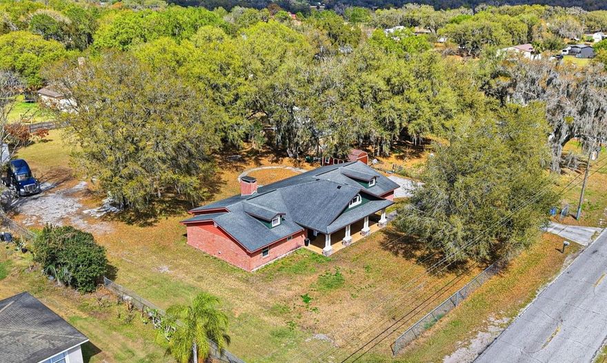 One or more photo(s) has been virtually staged. OFFERING FREEDOM, LAND, AND FLEXIBILITY. USE YOUR PROPERTY THE WAY YOU WANT. Recently remodeled and set on a full acre with NO HOA or deed restrictions, this one-story brick home offers the rare ability to live, park, and work without limitations. Bring your RV, boat, trailers, work trucks, equipment, and more. Zoned AS-1 with work/live flexibility, detached structures allowed, and potential for an ADU for added income, this property delivers true versatility. Major updates completed in 2023 include roof, appliances, and well pump for added peace of mind. (Virtually staged photos also include virtual renovation of an updated and open kitchen to illustrate potential) Conveniently located near SR-39 and SR-60 with easy access to I-4 and I-75, this property offers the perfect balance of space and accessibility. Enjoy peaceful surroundings with open land and estate-style homes while staying connected to the Tampa–Lakeland corridor, major employers, and daily conveniences. The home features 3 bedrooms, 2 bathrooms, and an open layout designed for comfortable living and entertaining. Natural light fills the space, and a wood-burning fireplace adds warmth and character. The kitchen offers ample cabinetry, granite countertops, and a functional layout with both dining and breakfast areas. The primary suite includes a private bath, while two additional bedrooms provide flexibility for guests, family, or office space. Step outside to a large covered lanai ideal for outdoor dining and relaxing while overlooking your fully fenced acre shaded by mature fruit trees—mango, avocado, lemon, and starfruit! Additional highlights include an oversized two-car garage, extended curved driveway, dual access points for easy entry of larger vehicles, and a large storage shed for tools, equipment, or hobbies. Located in the heart of Plant City, one of the last areas in Hillsborough County where buyers can still own land with this level of flexibility and value, this property stands out as an increasingly rare find, especially at this price point. As growth continues to expand east from Tampa, demand for usable land is rising while opportunities like this continue to shrink. Everyday essentials including grocery stores, dining, shopping, and healthcare are just 5–10 minutes away, along with downtown Plant City, the Florida Strawberry Festival grounds, Lumley’s Farm & Market, and outdoor destinations like Edward Medard Regional Park and Alderman’s Ford Park for boating, fishing, and trails. Ideal for business owners, contractors, hobbyists, RV enthusiasts, or buyers seeking multi-generational living or income potential, this property offers flexibility that is becoming harder to find in today’s market. Whether you need space to operate, store equipment, build additional structures, or simply enjoy the freedom of owning usable land, this property delivers. The dual access points and expansive layout make it especially functional for larger vehicles, trailers, or future expansion. Opportunities offering this combination of land, location, flexibility, and price point are quickly disappearing, making this not only a lifestyle purchase but a strategic long-term investment. A rare opportunity to secure space, freedom, and future potential in one of Hillsborough County’s most sought-after growth corridors. Schedule your private showing today!