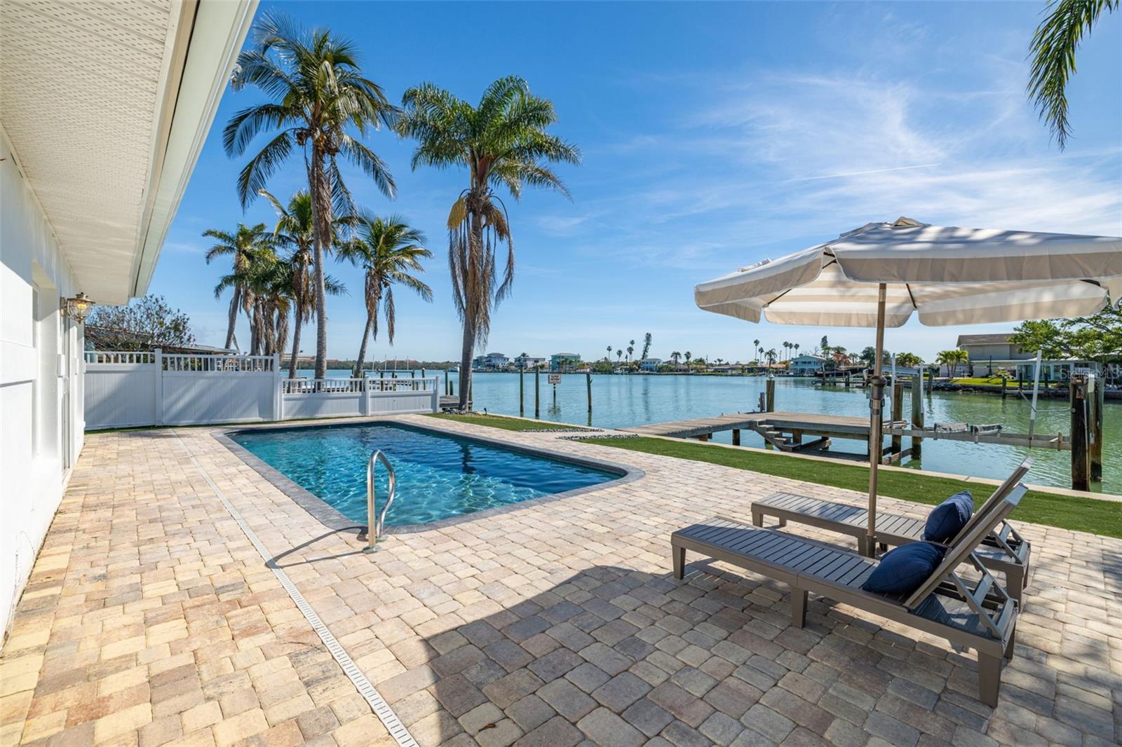 Looking for a waterfront home with incredible views? Your search ends here! Remediated and renovated after the 2024 hurricane season, this home is move-in ready, just in time for summer. Step inside to an open floor plan with stunning water views throughout the living space. The kitchen has quartz countertops, a waterfall island, new cabinetry and stainless steel appliances. Flowing seamlessly from the kitchen, the dining area and living room offer spectacular water views. The primary suite features a spacious en-suite bath with a new vanity, LED-mirror and shower. A large laundry room provides extra convenience, while the generously sized third bedroom sits on the opposite side of the home. Outside, enjoy beautiful pavers surrounding the pool, new vinyl fencing, low-maintenance turf, a wood boat dock and a boat lift. Additional updates in 2025 include a new electrical panel, updated wiring, a new HVAC system, new pool heater and pool pump, and a new roof. In the golf-cart-friendly community of Madeira Beach, this home offers easy access to local festivals, boat parades and ROC Park, a hub for outdoor activities with a fishing pier, playground, splash pad, dog park, butterfly garden, baseball fields, and tennis and basketball courts. Plus, you’re less than a mile from Caddy’s Madeira Beach, Candy Kitchen and pristine white sand beaches. This is the ultimate beach house so don't miss your chance to own a slice of paradise!