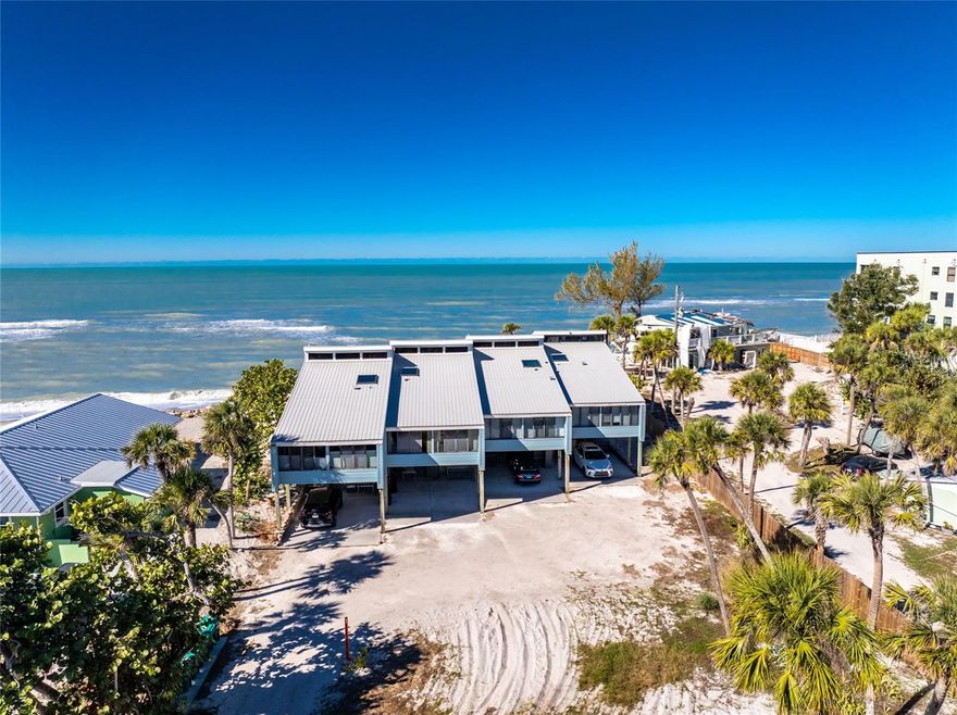 Welcome to Banyan Bluff Condominiums, a private four-residence townhome community set directly along the Gulf front of Manasota Key in Englewood, Florida. This lovely 3-bedroom, 2-bath multi-level townhome offers privacy and a tranquil atmosphere, positioned on more than an acre and comfortably set back from North Beach Road for added seclusion. The first living level is elevated on pilings approximately 16 feet above sea level, and the layout maximizes sweeping Gulf views and breathtaking sunsets from most rooms. A covered balcony off the main living area creates an inviting indoor-outdoor living space, ideal for dining outside or unwinding at day’s end. The beautifully updated kitchen includes new stainless steel appliances and quartz countertops. Upstairs, the top floor primary bedroom suite offers a vaulted ceiling, walk-in closet, an updated en-suite bathroom, and recently replaced storm-rated sliders that open to a private open balcony overlooking the Gulf. Both guest bedrooms include storm-rated windows and the guest bathroom is located just beyond the kitchen and adjoining dining area. Convenient parking includes two under-building spaces and an EV charging port. The tiled entry foyer includes an adjoining utility room with a new washer/dryer, utility sink and room for storage. The townhome is being offered turnkey furnished. Whether you choose to make it your own or place it in a rental program, this condo offers outstanding versatility. Banyan Bluff residents also enjoy a Gulf-front wooden deck, perfect for soaking up the sun or enjoying evening sunsets. Other notable updates include a metal roof in 2023, a newer electrical panel, and tankless water heater. A rare opportunity to own a stunning beachfront townhome in a quiet, exclusive setting.