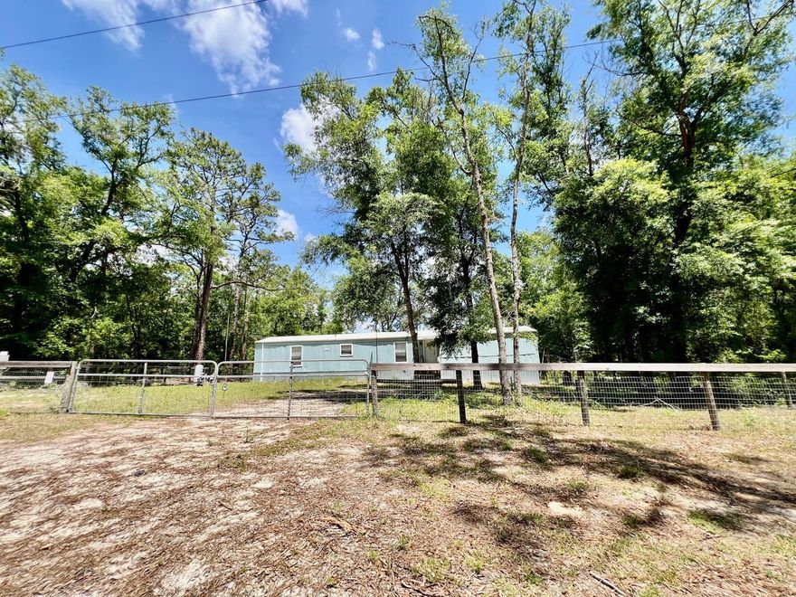 Welcome to modern rural life! This property of 3 bedrooms and 2 bathrooms is a dream come true for those looking for a house with land and contemporary comforts. Whether you like gardening, need additional storage space, or value privacy, this house has everything! This property is completely fenced with gates for more privacy and security. Located in the heart of Levy County, just 20 minutes from Gainesville, Bronson is surrounded by the natural beauty of nearby springs and rivers, and the Gulf of Mexico is a short drive away. With easy access to schools, shops, parks, and major highways, Shands, HCA, and VA hospitals, and the University of Florida in Gainesville are also easily accessible., For horse lovers, the World Equestrian Center (WEC) is less than 25 minutes away. Call today to see this great property for yourself!