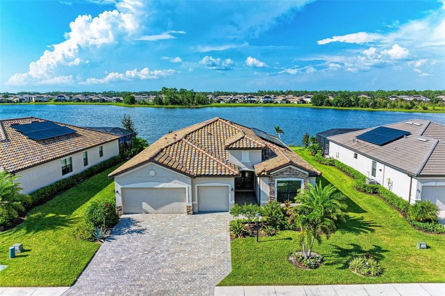 Welcome to the epitome of Florida living in the amenity-rich and maintenance-free community of Polo Run. Located on one of the most expansive and private premier water lots, this practically brand-new home offers the perfect blend of modern luxury, airy spaciousness, and tranquil waterfront views. Step into your personal paradise that has impeccable landscaping and sweeping lake vistas. The open-concept design seamlessly connects the great room to the outdoors, where you'll discover a covered patio and a fully screened-in pool and spa area, that was intentionally and beautifully landscaped with aesthetics and privacy in mind. This outdoor haven is tailor-made for year-round enjoyment and entertaining, ensuring you make the most of Florida's beautiful weather. The great room features an ultra-modern electric fireplace with a rock surround, providing both warmth and ambiance. The GOURMET KITCHEN is a chef's dream, complete with an oversized island, pristine cabinets, stainless steel appliances, a built-in oven, a gas cooktop, a hooded exhaust vent, and a spacious pantry. It's the perfect space to unleash your culinary creativity. The luxurious and spacious MASTER SUITE is a retreat unto itself, boasting a stunning lake view, two walk-in closets, and an ensuite bathroom with separate vanities and an oversized shower. The additional bedrooms are generously sized compared to most homes, and the third bedroom serves as a guest suite with a private adjoining bathroom. A bonus room, accessed through elegant French doors, offers endless possibilities, whether you choose to use it as a den, study, or home office. COMMUNITY FEATURES: Polo Run offers a gated community, eliminating the need for yard maintenance, and allowing you to focus on enjoying the exceptional amenities. These include a beautiful clubhouse, state-of-the-art fitness center, resort-style pool and spa, sports courts for basketball, tennis, pickleball, and bocce ball, as well as various areas of open space for relaxation. The community is also pet-friendly with a dedicated dog park and strategically placed dog waste cleanup stations. A lively calendar of events for all ages ensures that neighbors come together year-round. OTHER NOTEWORTHY FEATURES: Overhauled Landscaping Design, Coffered Ceilings, Tray Ceilings, Upgraded Crown Molding, SMART Home features(including front door lock, garage door openers, RING doorbell, and thermostats), Tankless Water Heater, Low-Maintenance Tile Roof, Laundry w/ sink, Upgraded fixtures, Shutters, No Carpet, An Abundance of Natural Light, and Incredible Lake Views.