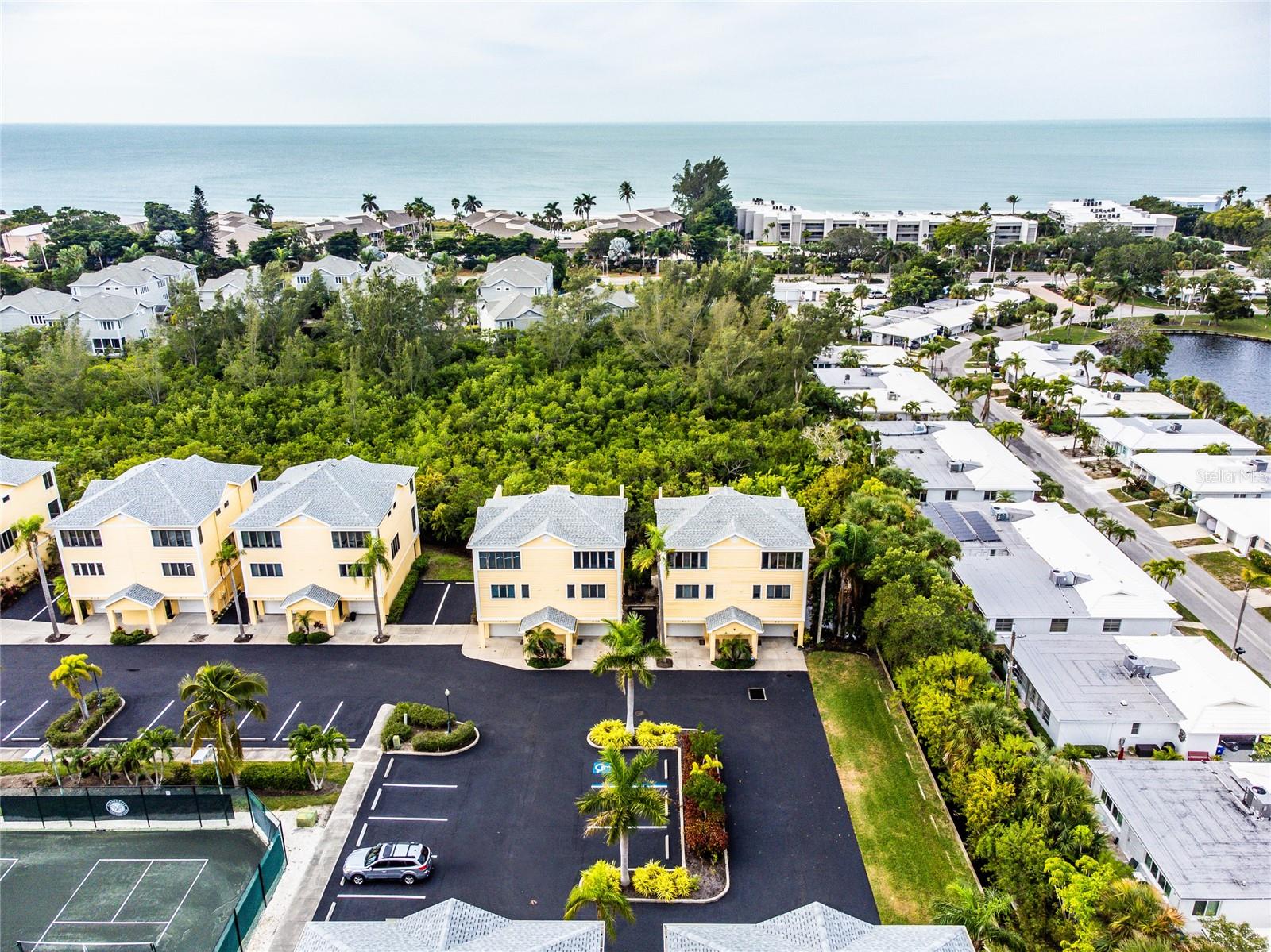 Welcome to your cozy island townhome at the north end of Longboat Key. Perfect as a fulltime residence, seasonal retreat, or investment property, this one-bedroom, two-bath unit fits your needs. This two-story property weathered three hurricanes in 2024, sustaining only minor flooding in the garage during Hurricane Helene and a cracked top-floor window during Hurricane Milton. The HOA will cover and replace the window. On the ground floor, enjoy your private parking garage and storage space. The main living area on the first floor features an open-concept living room and kitchen, ideal for relaxing or entertaining. Step out onto the screened balcony to enjoy the natural beauty of Florida or unwind with your morning coffee. This floor also has a full bathroom and a pull-out sofa for
hosting guests.
The second floor boasts a spacious master bedroom with a king-sized bed and two walk-in closets, filled with natural light from large windows. This level includes a second bathroom and a sun deck with an outdoor shower, offering peaceful views of a natural reserve. It’s the perfect spot to soak up the sun or enjoy a good book in a hammock. Short-term rentals with a 14-day minimum stay are allowed, adding investment potential. From July 2024 - July 2025, the home already has booked rental income booked totaling $45,0000.
With some cosmetic upgrades, this could be even more! The unit is part of a top-notch tennis club that now includes two pickleball courts. You'll be close to the pool and the island’s beaches. Pet-friendly and welcoming, the community features a Junior Olympic-sized pool, a Tiki Bar, and a restaurant for a resort-like feel. Nature trails wind through the property, leading to a dock with stunning views of Sarasota Bay—
perfect for launching your kayak to explore mangrove tunnels or paddle alongside manatees and dolphins.
Whether you're into kayaking, tennis, pickleball, cycling, or jogging in nearby John Durante Community Park, this condo offers the perfect balance of luxury and leisure. Your island paradise is waiting—make it yours today!