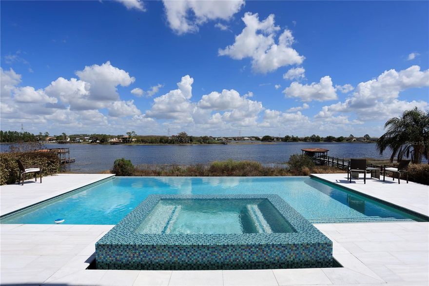 One or more photo(s) has been virtually staged. Beautiful Winter Garden lakefront home with 270-degree lake views, a resort pool, and location, location, location. This one-story, four-bedroom, four-bath open floor plan home features a modern infinity-edge pool overlooking stunning views of Lake Hancock, with an oversized fenced-in backyard. Just three minutes to everything in Hamlin.

The home also features an office/flex room and is located three minutes off 429 and New Independence Parkway, 30 minutes to the Orlando International Airport, 25 minutes to downtown Orlando, 20 minutes to Disney World, 12 minutes to Winter Garden Village, and 3 minutes to the movies, theaters, several restaurants, and shopping.

This property has one of the best views on Lake Hancock in one of the best locations — a one-of-a-kind lakefront home in Winter Garden, Florida, that you must see for yourself.