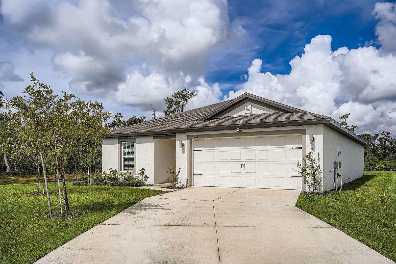 Riverstone is graced by this inviting, cozy home. Nicely placed on a corner lot, with a water view, this home offers residents privacy with a split bedroom floorplan. The kitchen is adorned with dark cabinets, granite countertops and a center island. Smartly updated with a Vivant security system and electronic shades in the breakfast nook, family room and primary bedroom. The lanai also offers an electronic shade to enjoy the lake view. In addition to a beautiful house, the community offers residents miles of walking and biking trails, dog parks, playgrounds and community pools.