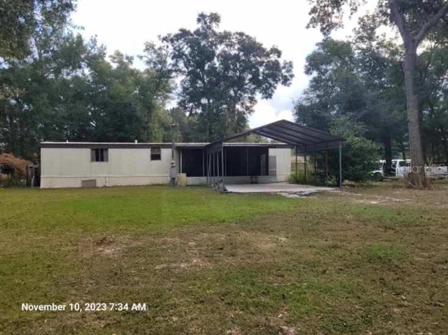 Want less than a mile to the World Equestrian Center 80th Ave Gate? This property has no Deed restrictions with endless income or development possibilities . It is a big 2.5 Acres with a cute,clean 1982 Manufactured Home, a 12x40 adorable finished "tiny house" with independent septic, electric and a 30 Amp RV Hook up with a second RV Hookup possible. Horses allowed, 3 sources of income with potential for more on this property. Building shown in picture is the tiny house. It is possible to assemble this property with the adjacent two 7+/- acres.  See OM654400 that would give road frontage on soon to be 4 laned 80th Ave.It is located behind the EMU Farm on 80th.