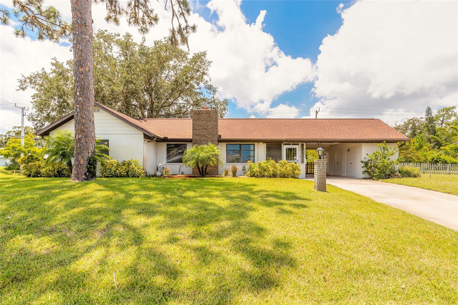Are you looking for a home where you can have all your toys and room to grow? Look no further. This 3 bedroom 3 bath home has room galore! This home could be a 5 bedroom or in-law suite, den, office or family room. So much potential. Kitchen features granite counter tops, cherry wood cabinets, ample amount of cabinets and an extra room that could be your butlers nook. The laundry room is very spacious with a walk in closet to store extra pots & pans, dishes, or make it into a huge pantry. Real wood burning fireplace adds a significant element of coziness and warmth to your living room. Primary bedroom features 2 walk in closets along with a spacious bathroom & vanity. The home is situated on a 125' X 187' partially fenced corner triple lot. If you always wanted a vegetable garden there is plenty of room for that and a pool. Huge side driveway with an area to park your RV, boat or any other toys you might have and a 2 car garage that leads you into the laundry area and kitchen. The front of the home has a handy 1 car carport with storage area and enter into your screened porch to your living room from this convenient carport. Don't dream too long, you might miss this opportunity to own your ideal home. Please put it on your must see list today!