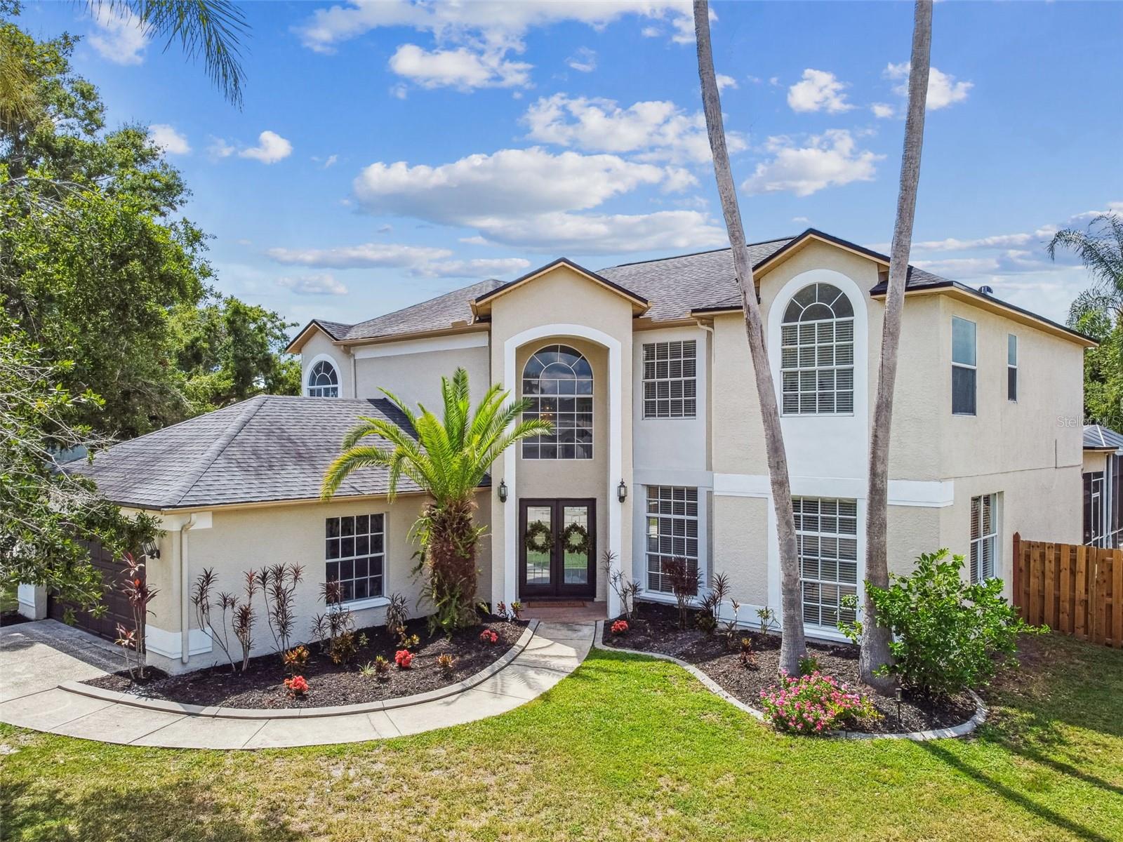 Welcome to this beautifully updated 5-bedroom, 3-bath, two-story POOL home (6 ft. deep)in the highly sought-after, family-friendly Northwood community—known for its peaceful streets, mature landscaping, and welcoming atmosphere. Perfectly positioned on a premium corner lot backing to a tranquil pond, this home offers privacy, plenty of natural light, and inviting indoor/outdoor living spaces ideal for entertaining or unwinding. Recent upgrades include: NEW interior paint throughout, NEWLY painted cabinets, NEW LVP flooring and NEW carpet, NEWLY painted exterior trim, FRESH landscaping. DOWNSTAIRS: Step into two spacious living areas, a formal dining room, a private office, and a gourmet kitchen complete with quartz countertops, wet bar, and two pantries. Large sliders open to the expansive screened pool and spa, outdoor kitchen, and covered lanai—perfect for game days, birthday celebrations, or quiet mornings by the water. UPSTAIRS: The split-bedroom layout features an owner’s suite oasis with his-and-hers walk-in closets, set apart from the additional bedrooms for privacy yet close enough to keep loved ones nearby. Additional highlights: Very well-maintained roof (8 years old), Office on main floor. Laundry room, Outdoor kitchen and mature landscaping. Potential to enlarge the yard with a simple fence adjustment, maximizing your private outdoor retreat. Prime Location: Easy access to I-75, I-275, and Veterans Expressway. Minutes to Tampa Premium Outlets, Wiregrass Mall, Costco, Publix, Target, and more. Close to Florida Hospital, top medical care, and outdoor recreation at Suncoast Trail and Flatwoods Park. This exceptional home offers space, style, and location—schedule your private tour today before it’s gone!