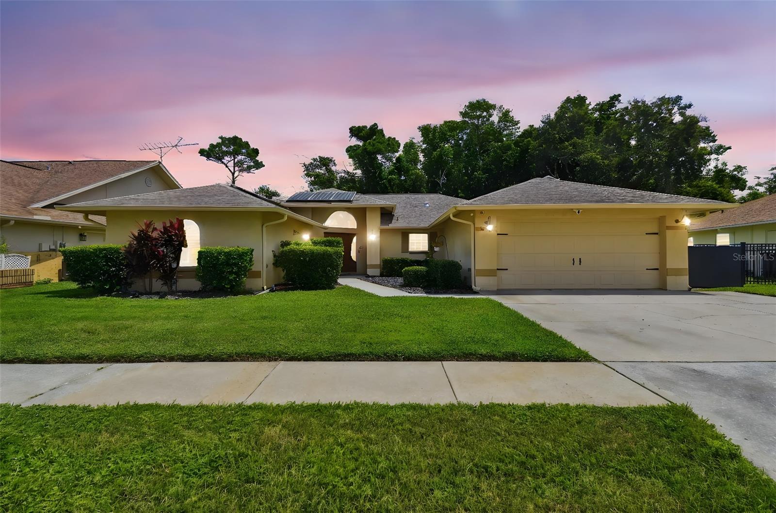 Opportunity Knocks! This home offers a complete in-law suite with a kitchen, living room, and a spacious bedroom with a private bathroom. The bedroom has its own access to the outdoor living space, swimming pool, and A/C system. Whether you need a multi-generational home, an in-law suite, an attached guest home, or an independent living space for a young adult, this setup might be perfect for you. Located in the beautiful community of River Crossing, this home boasts a central location. Step into the foyer and living space, featuring real wood floors, a remodeled kitchen with granite countertops and solid wood cabinets, and a large living room overlooking the kitchen. This layout is ideal for keeping the chef close to family and guests. If you enjoy entertaining, you’ll appreciate the open and airy living space with skylights, a bar, and a formal dining area for family dinners. The plantation shutters add a touch of charm to the home. The primary bedroom is private, complete with double closets and an en-suite bathroom with a rainfall shower and jets on the shower wall. There is a tankless hot water heater too. Additionally, there’s a private backyard with a saltwater pool and spa, perfect for relaxing evenings. The color-changing LED pool lighting sets the mood for any occasion. Privacy is never an issue, as there are no rear neighbors. To save on energy costs, the home comes with 32 solar micro panels. The average electric bills during the summer are around $150, while in the winter, they’re approximately $60. Three air conditioners and a whole-house generator powered by propane ensure you’re prepared for the hurricane season or any power outages. This home is conveniently located near shopping, restaurants, and all the amenities you need.