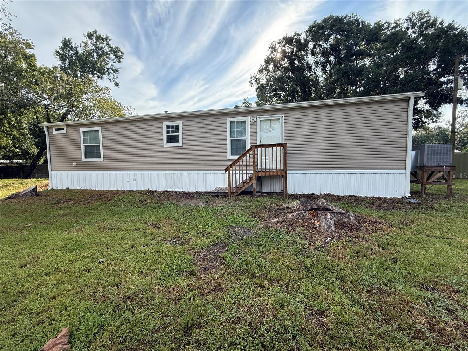Country living! This 2021 Champion Homes, Trinity model (16 x 56') Features 2 bedrooms, 2 bathrooms and 849 SF of living space. This home is on the same lot as the main home however, the yard has been separated so you have privacy. The private gate & fenced yard gives you lots of room to roam. Beautiful Vinyl flooring really accentuates your décor. Carpet flooring in the bedrooms adds warmth and is comfy on the feet. Updated kitchen appliances include range, refrigerator, and dishwasher. The stylish kitchen boasts plenty of cabinet & counter space and plenty of room to make it an eat-in kitchen. Master bedroom features a walk-in closet and full bath for privacy. Window blinds allow in just the right amount of light. Ceiling fans will be sending you a cool breeze. Efficient Central AC and Heat for year-round comfort. Washer/Dryer CONNECTIONS for your convenience. There is gate access in the front & rear of property with full perimeter fencing for the pets. The Hillsborough river runs through the woods behind this property. There is no HOA and no deed restrictions. Pasco County water and septic system. There is a carpet cleaning fee of $200. Non-refundable pet fee $400 - (no aggressive breeds). Hurry!