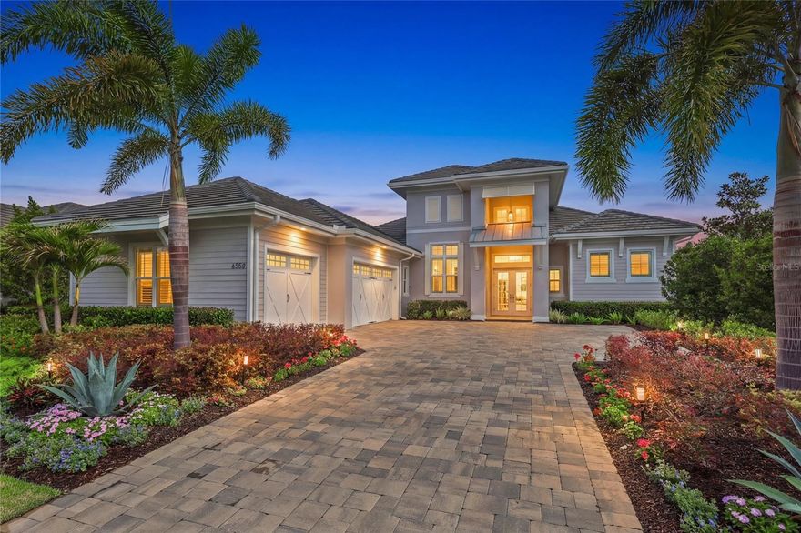 Crafted in 2023, this expansive residence blends timeless elegance with modern comfort on a private homesite. A grand open-concept layout showcases soaring ceilings, designer light fixtures, upscale finishes, and high-impact windows and doors that fill the home with natural light.
The gourmet kitchen is a chef’s dream, beautifully appointed with custom wood cabinetry, premium appliances, and a large island that flows seamlessly into the dining area and great room. Ten-foot disappearing glass sliders extend the living space outdoors, where a panoramic screened retreat awaits. The outdoor living area is enhanced by a full stainless summer kitchen, gas fireplace, and an oversized heated saltwater pool and spa, perfect for entertaining or relaxing in style. Enjoy peaceful views of lush greenery with no homes directly behind you, providing a tranquil and secluded escape.
The private primary suite offers tray ceilings, two oversized customized walk-in closets, and a spa-like bathroom featuring double vanities, freestanding soaking tub, and a walk-in shower with seamless glass. A fourth guest bedroom with a built-in Murphy bed provides a versatile dual-purpose space, and the adjacent full bathroom also functions as a convenient pool bath. Additional features include insulated garage doors and impeccable custom storage throughout, including California Closets and pantry. The home also includes a custom-designed half bath for ultimate convenience.
Located within the exclusive gated community of The Lake Club, residents enjoy a truly elevated lifestyle with access to exceptional amenities including two resort-style heated pools, the Grande Clubhouse with fine dining and bar, fitness and wellness center, luxury spa, tennis and pickleball courts, playground, dog park, and the personalized service of a full-time concierge and activities director.