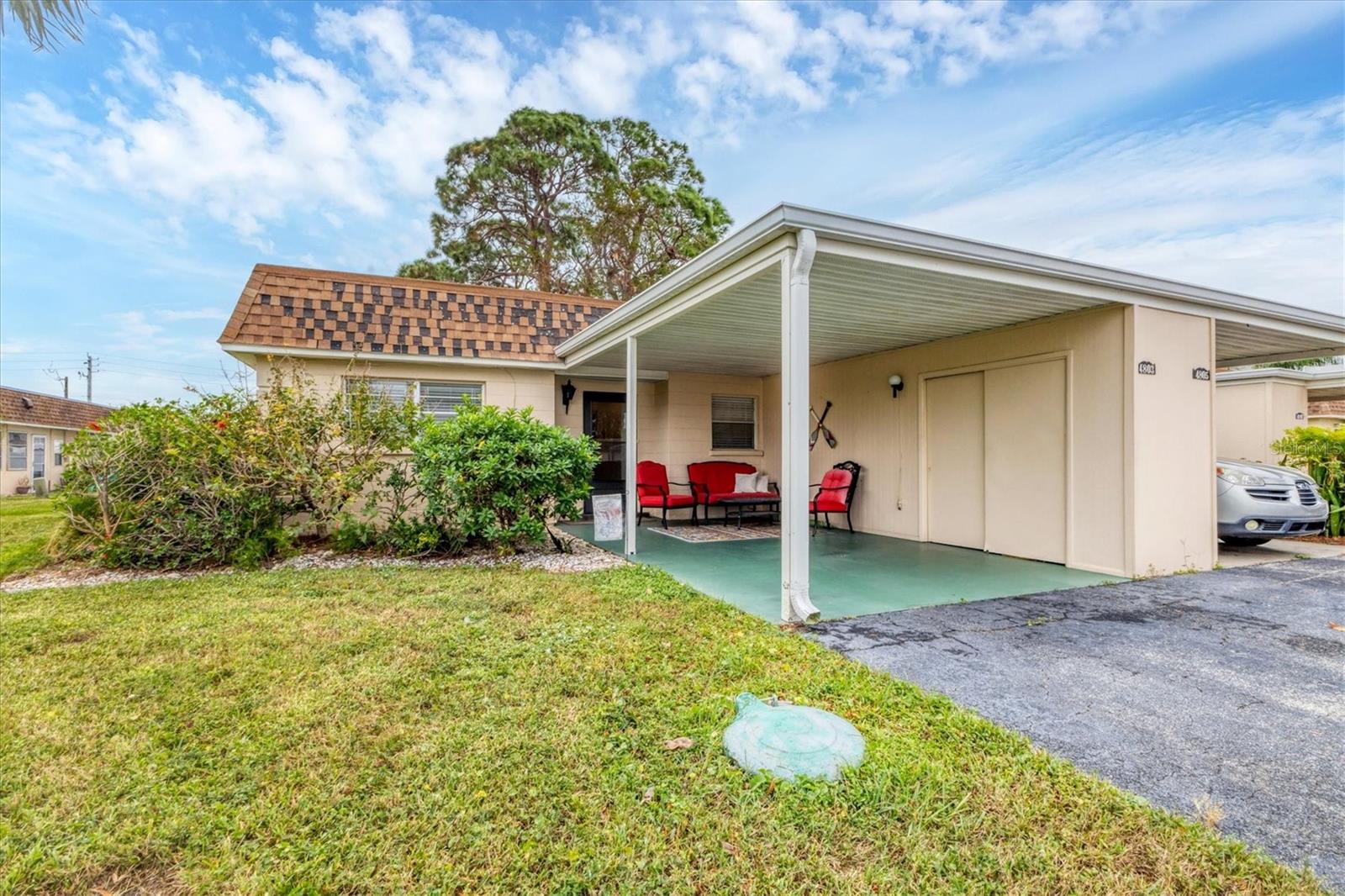 Experience the Florida lifestyle in this affordable maintenance free home, perfect for either snowbird or year-round living! This charming 2/2 villa is sturdy concrete block construction with attached carport, exterior storage and additional parking in driveway. New luxury vinyl plank along with tile flooring throughout for easy maintenance as well as an updated guest bath. Ideal floor plan with living/dining room combination and split plan for privacy. The spacious master bedroom has en suite bath with step in shower and a walk-in closet. The glass enclosed Florida room offers an additional sunny flex space with an exterior door and laundry closet with full size washer and dryer. Roof new in 2018 and AC 2019. This vibrant 55+ pet friendly community has a heated community pool for year-round enjoyment, clubhouse and shuffleboard just steps away from your door. Fees include exterior maintenance, cable and internet, recreation facilities, trash/recycle and manager. Great central location in West Bradenton convenient to shopping, restaurants, hospitals, public transportation, downtown Bradenton/Riverwalk and SRQ Airport. Don't miss this opportunity!