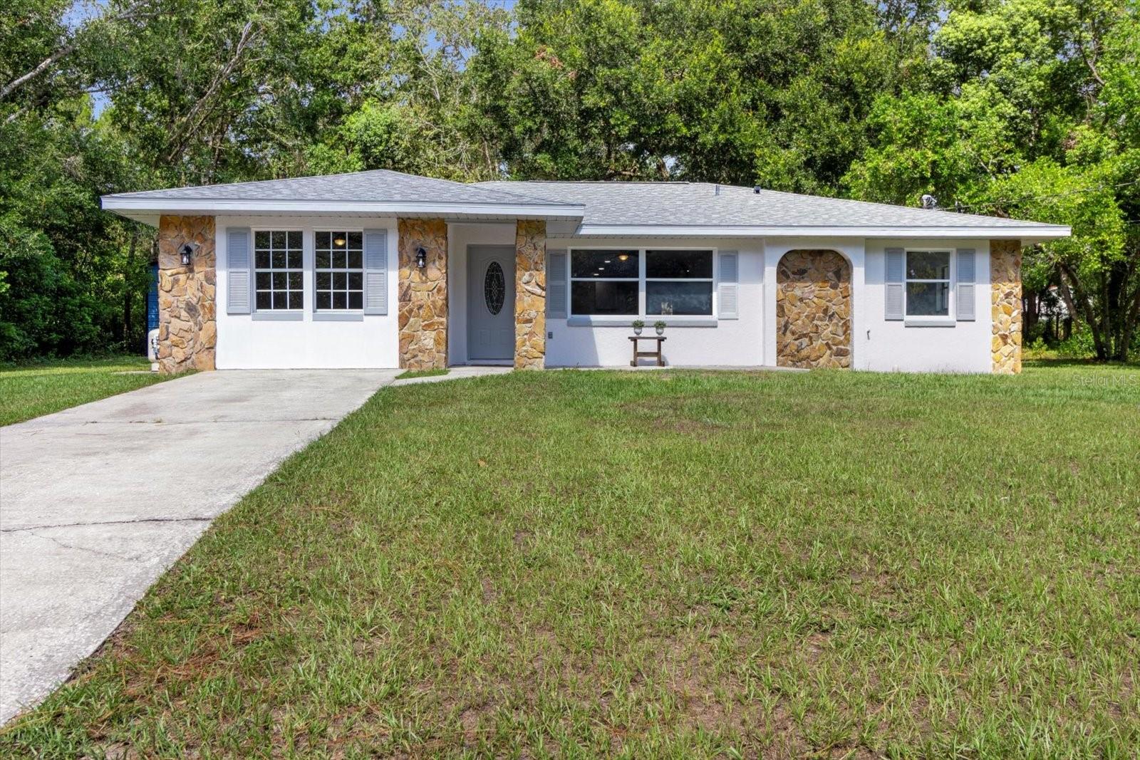 The Home You’ve Been Waiting For! Polished, pretty, and completely move-in ready, this charming 3-bedroom, 2-bath home with bonus room easily converts into a fourth bedroom. This beauty is nestled on a spacious half-acre homesite with room for all your toys and hobbies with an ample 2 car garage with extra tall roll up bay doors. With no deed restrictions, yet surrounded by a well-kept neighborhood, pride of ownership shines here. A brand-new roof in 2025 and easy-care luxury vinyl flooring throughout set the stage for stress-free living. The open floor plan offers comfort and flexibility. Great room layout affords a versatile living space. Additional Den makes a great home office space too! The sparkling kitchen with new stainless appliances will inspire your inner chef. Room for gathering or entertaining. The generous owner’s suite features a relaxing jetted tub, a separate enclosed shower, and plenty of space to unwind. Need more? The bonus room easily converts into a fourth bedroom, craft space, football den, or gamer’s retreat. Step outside to your shady, wooded backyard, a peaceful escape for morning coffee or evening gatherings. The detached two-car garage with extra-tall bays and a concrete floor provides ideal space for storage, projects, or a workshop. Homes like this don’t come along every day—schedule your showing before it’s gone!