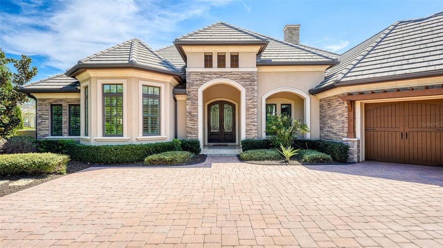 A timeless masterpiece by Arthur Rutenberg Homes, this breathtakingly tranquil residence is enveloped by lovely landscaping, tropical palms and
a protected preserve on over half an acre home site in THE LAKE CLUB. Florida’s natural beauty is elegantly showcased throughout the spacious
interiors where organic finishes and sophisticated features harmonize. Entering through the oil-rubbed iron glass doors, mesmerizing flow is
complemented by arched wall niches, stone and textured accents, painted double tray ceilings, and gorgeous hickory hardwood floors. A grand
great room transitions effortlessly onto the screened lanai through impact pocketing sliding doors and into the impressive chef’s kitchen and
dining room. Express your culinary skills with Brookhaven custom maple cabinetry, exposed beam ceiling, extended island for gathering, granite
counters, gas cooktop with pot filler, tile backsplash, and built-in desk. Disappearing corner, impact pocketing sliders in the dining room allow for
a complete indoor-outdoor experience when you need access to the built-in outdoor kitchen with a tongue-and-groove ceiling and fireplace for
dining alfresco in the covered area that connects to the game room. The quintessential home for entertaining, the bonus/game room connects
off the lanai through disappearing corner impact sliders and is decorated with an exposed brick wall and features a wet bar, card table nook, and
overlooks the lake and preserve. Enjoy the refreshing heated pool with sun shelf and waterfall for a serene atmosphere surrounded by nature
and privacy. The split floor plan ensures solitude to the two guest bedrooms and especially the master retreat boasting a sitting area with lanai
access and lake views, and a luxurious en-suite bath with dual sinks, make-up vanity, a soaking tub, and a walk-in shower. Exceeding
expectations of needs and wants, there is a stunning study including a sitting space with wood-beamed coffered ceiling adding drama. An
unbelievable oversized, air-conditioned three-car garage turned man-cave, fashioned in floor-to-ceiling tongue and groove pinewood wainscoting,
pub tin ceiling, insulated and encased garage doors, and a half-bath with custom built-in cabinetry. Every thoughtful detail was meticulously
considered when designing this Florida Green Builder Certified residence, including Low-E impact sliders and casement windows, Levitron dimmer
switches, surround sound, Generac house generator, central vacuum, tankless water heater, and Platinum Control 4 home automation. The
perfect home does exist, and this is it. Furnishings available with a few exceptions.