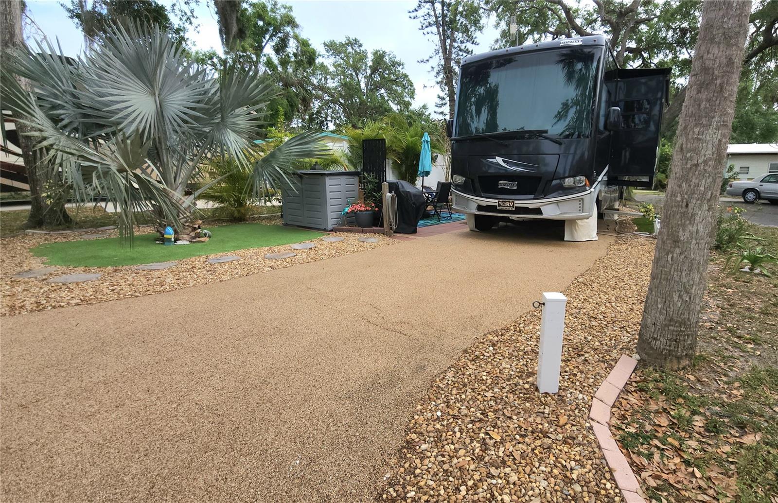 UNIQUE, LANDSCAPED RV LOT IN ACTIVE 55+ COMMUNITY! This pull-through RV lot is located in SUGAR CREEK RESORT. Nestled in the back of the community, this quiet spot is on a curved end lot. Pebble treatment on the pavement and a 10' x 26' patio add to the charm. There is a granite topped buffet table which enhances your outdoor experience. Included with the lot is a grill, furnishings, and a cabinet shed where you can store your gear. HOA fees of $442 each quarter include water, sewer, trash, and grass mowing. Amenities include heated pool, clubhouse, tennis, pickleball, shuffleboard, workshop, laundry and shower facilities. Don't miss out on this slice of Florida paradise.