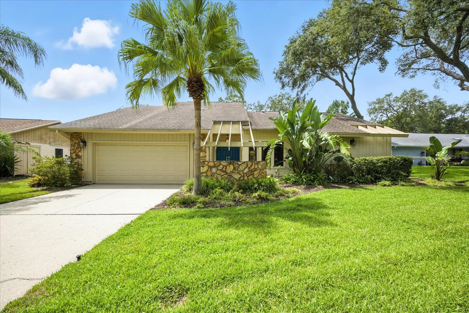 One or more photo(s) has been virtually staged. Location, Location, Location – and So Much More!
Welcome to your dream home in the coveted Valencia Lakes community of Palm Harbor. This stunning residence offers an unbeatable combination of location, space, and style. Situated on a fabulous lot in one of the area’s most sought-after neighborhoods, this property is a true gem from the moment you arrive.
As you pull into the driveway, you’ll be greeted by manicured landscaping and exceptional curb appeal. The double-door entryway opens to a warm, light-filled foyer that immediately makes you feel at home. Vaulted ceilings and expansive windows allow natural light to flood the living spaces, creating an inviting atmosphere from the very first step inside.
At the heart of the home lies the spacious kitchen, designed for both everyday living and entertaining. It features generous counter space, sleek stainless steel appliances, a closet pantry, and a layout that flows seamlessly into the dining area. Picture yourself enjoying meals while overlooking your private backyard paradise and sparkling pool.
The sunken family room is a true showpiece, boasting soaring ceilings, a cozy fireplace, and a wet bar—perfect for hosting guests or enjoying a quiet evening in.
The master suite is a retreat of its own, featuring a large walk-in closet and an en-suite bathroom with a dual vanity and an oversized, private walk-in shower. The split floor plan ensures privacy, with the second bedroom located off the family room. The second bathroom, which doubles as a pool bath, provides both convenience and additional storage.
Head upstairs and discover a spacious bonus room with a full closet—ideal as a guest room, home office, or media space. Sliding glass doors open to a private deck, offering serene views of the beautifully landscaped backyard.
Step outside, and you’ll find yourself in a lush, fully fenced oasis. The backyard features tropical landscaping, ample green space, and a large pavered pool area designed for entertaining. Whether you’re hosting a summer barbecue, lounging by the pool, or enjoying a peaceful evening under the stars, this outdoor space is pure perfection.
Additional features include:
• Abundant storage throughout the home, including under-stair storage and linen closets.
• Oversized 2 car garage
• No carpeting
• Already plumbed for outdoor kitchen
• Elegant architectural details that enhance the home’s charm and character.
• Community park and playground
• A prime location just minutes from shopping, dining, world-renowned beaches, golf courses, and both Tampa and St. Petersburg airports.
This isn’t just a home—it’s a lifestyle. Come experience the perfect blend of comfort, elegance, and convenience in one of Palm Harbor’s premier communities.