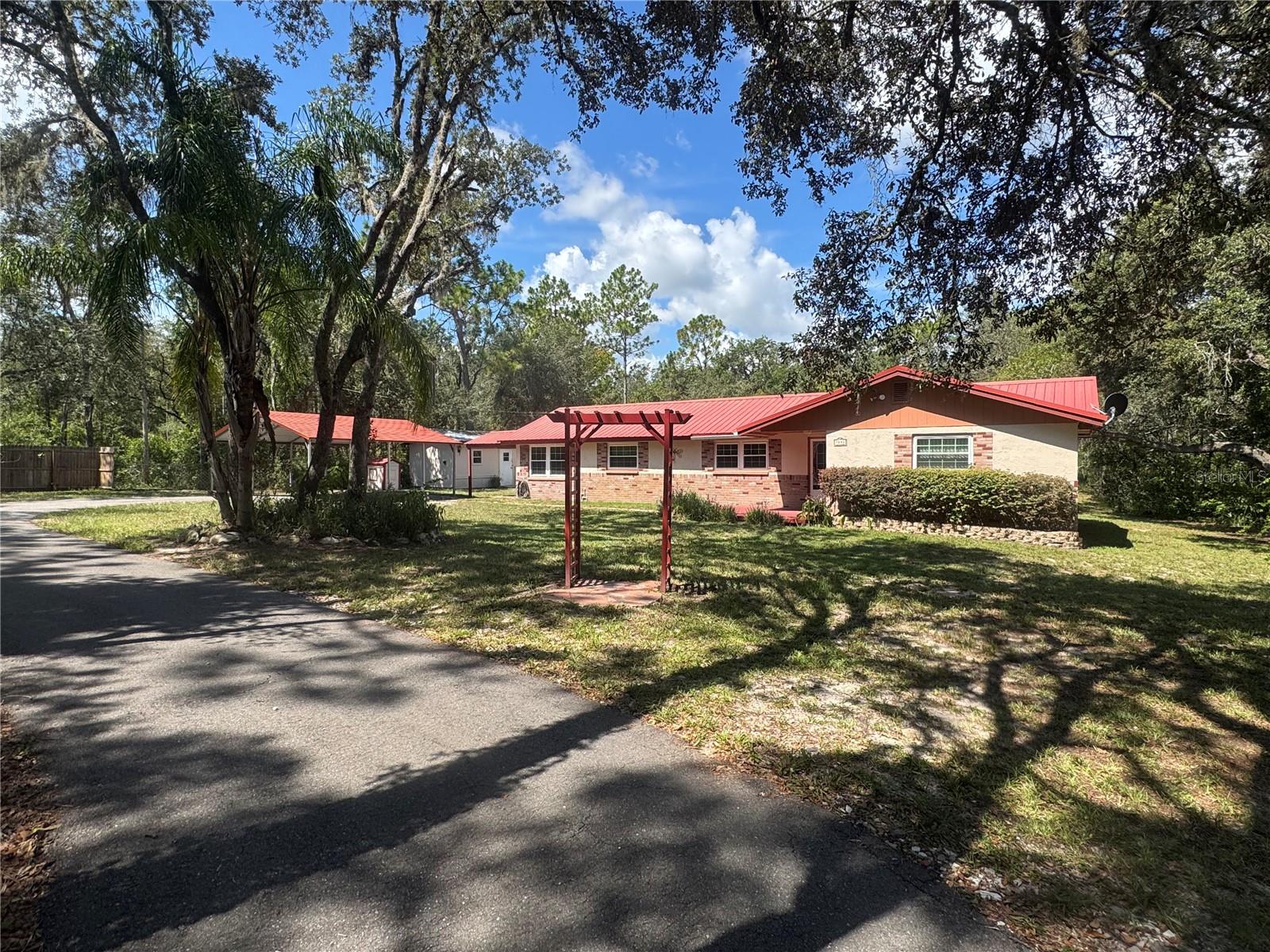 Discover the potential of this charming property, situated on 1.16 acres of natural beauty with mature landscaping, towering trees, and a peaceful country setting. A paved front driveway welcomes you home. While the residence does require some TLC, it offers the perfect blank canvas to create your dream retreat.
Ideally located just minutes from I-75, US-301, and Highway 50, and only 70 miles from Orlando, you’ll enjoy the best of both worlds—tranquil living with convenient access to major destinations. Notable updates include a new HVAC system (2019), septic pumped (2018), and an updated pool pump and compressor.
A newly opened fire station is located just 1.9 miles away, and nearby you’ll find access to the Withlacoochee River and Withlacoochee State Trail, perfect for outdoor enthusiasts. With no HOA or deed restrictions, you can Airbnb a rental to generate extra income. Bring your animals, recreational toys, and big ideas—the possibilities are endless.