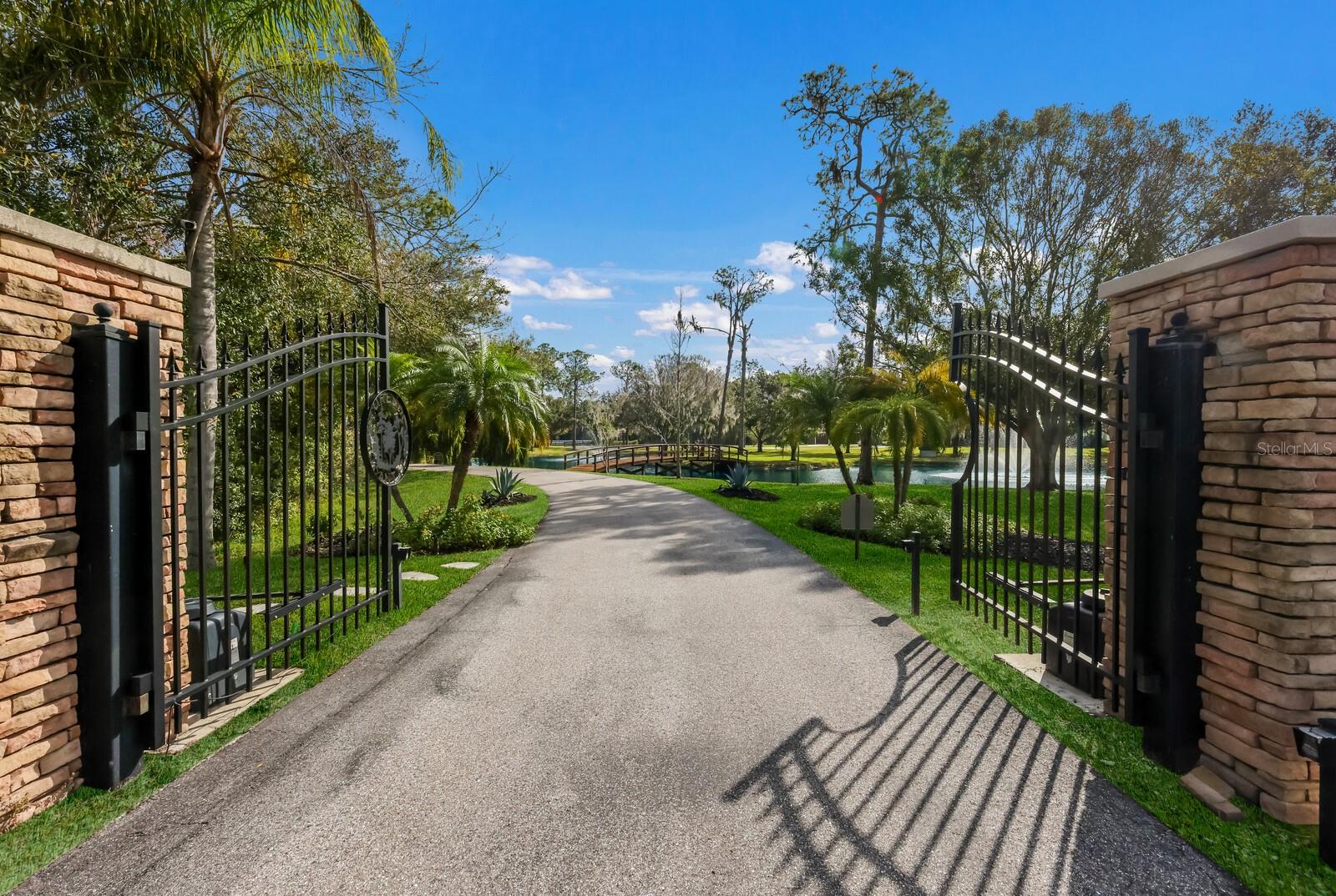 Nestled within the highly sought after equestrian community of The Forest at Panther Ridge, 6605 189th St E is a captivating 7.88 acre, fully fenced, residence that seamlessly blends luxurious living with the tranquility of a natural haven. From the moment you drive through the gates of this breathtaking property, boasting acres of Florida native and friendly flora landscaping, designed, and maintained by a Master Gardener, you will be transported to a world filled with unparalleled beauty resembling a botanical retreat. Imagine waking up to the sounds of nature and enjoying evenings under starlit skies or taking a stroll to your custom gazebo to watch the deer frolic and play. This custom designed residence and guest house offers 5,338 square feet under air and 7,674 sq ft total! Both the main home and guest home were thoughtfully renovated with no expense spared in 2019. This sprawling estate exudes a warm country lodge vibe with a modern elegance interior. The primary home offers three bedrooms all ensuite, a charming office with views of the one-acre pond with fountains and 66' custom bridge, an impressive theater room, chef’s kitchen complete with ice maker, gas Wolf industrial oven, and Subzero refrigerator. The family room is cozy yet elegant with authentic wood beams and a wood burning fireplace with gas starter. You will love the three car garage with custom built-ins and high-quality epoxy flooring. The unique material choices include stunning wide plank wood flooring, exquisite lighting creating a story throughout the home and ambiance for every occasion, custom brick wall in the dining room exuding old world charm and authenticity are a few favorites! The unrivaled selections are the perfect blend of form and function. The outdoor living space is a tropical oasis featuring an outdoor kitchen, heated saltwater pool, with fiber optics lighting options, spa, sun shelf, and captivating waterfall feature with custom pergola with motorized louvers. The travertine deck sets the stage for entertaining in the company of nature and under the “twinkle lights” pool cage creating a memorable evening with friends & family. The 2019 metal roof, impact PGT windows and doors, 35 KW whole house generator, spray foam Icynene insulation, MESH WIFI and 16 security cameras give peace of mind to the most discerning buyer looking for the ultimate in security and efficiency. The two-bedroom guest home attached to the air-conditioned, 4 car garage will delight car enthusiasts and offers endless options for storage, gym and more. Your guests won’t want to leave this charming cottage with a full kitchen with quartz counters, wood shaker cabinets and cozy screened porch for morning coffee or nights gazing at stars. Venture out to the cutest “she shed” you will ever see and admire the beautiful garden that only a Master Gardener could so eloquently create. The property is an experience and truly can’t be described in words. The pride in ownership of this storybook residence is apparent and nothing short of a tranquil oasis where resort living converges in perfect harmony with the serenity of nature. Panther Ridge is a sanctuary for those seeking a peaceful setting within nature, while still being just minutes to a multitude of amenities in neighboring Lakewood Ranch. The combination of stunning acreage, location, and two fully renovated living areas make this property a very rare find. Why not have the best of all worlds in this magical setting?