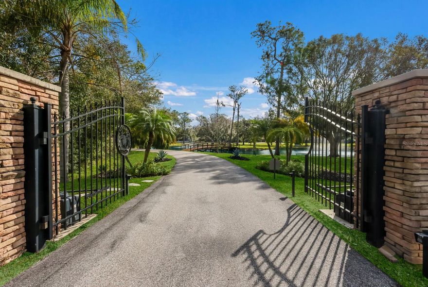 Nestled within the highly sought after equestrian community of The Forest at Panther Ridge, 6605 189th St E is a captivating 7.88 acre, fully fenced, residence that seamlessly blends luxurious living with the tranquility of a natural haven. From the moment you drive through the gates of this breathtaking property, boasting acres of Florida native and friendly flora landscaping, designed, and maintained by a Master Gardener, you will be transported to a world filled with unparalleled beauty resembling a botanical retreat. Imagine waking up to the sounds of nature and enjoying evenings under starlit skies or taking a stroll to your custom gazebo to watch the deer frolic and play. This custom designed residence and guest house offers 5,338 square feet under air and 7,674 sq ft total! Both the main home and guest home were thoughtfully renovated with no expense spared in 2019. This sprawling estate exudes a warm country lodge vibe with a modern elegance interior. The primary home offers three bedrooms all ensuite, a charming office with views of the one-acre pond with fountains and 66' custom bridge, an impressive theater room, chef’s kitchen complete with ice maker, gas Wolf industrial oven, and Subzero refrigerator.  The family room is cozy yet elegant with authentic wood beams and a wood burning fireplace with gas starter. You will love the three car garage with custom built-ins and high-quality epoxy flooring. The unique material choices include stunning wide plank wood flooring, exquisite lighting creating a story throughout the home and ambiance for every occasion, custom brick wall in the dining room exuding old world charm and authenticity are a few favorites!  The unrivaled selections are the perfect blend of form and function. The outdoor living space is a tropical oasis featuring an outdoor kitchen, heated saltwater pool, with fiber optics lighting options, spa, sun shelf, and captivating waterfall feature with custom pergola with motorized louvers.  The travertine deck sets the stage for entertaining in the company of nature and under the “twinkle lights” pool cage creating a memorable evening with friends & family. The 2019 metal roof, impact PGT windows and doors, 35 KW whole house generator, spray foam Icynene insulation, MESH WIFI and 16 security cameras give peace of mind to the most discerning buyer looking for the ultimate in security and efficiency.  The two-bedroom guest home attached to the air-conditioned, 4 car garage will delight car enthusiasts and offers endless options for storage, gym and more. Your guests won’t want to leave this charming cottage with a full kitchen with quartz counters, wood shaker cabinets and cozy screened porch for morning coffee or nights gazing at stars. Venture out to the cutest “she shed” you will ever see and admire the beautiful garden that only a Master Gardener could so eloquently create. The property is an experience and truly can’t be described in words. The pride in ownership of this storybook residence is apparent and nothing short of a tranquil oasis where resort living converges in perfect harmony with the serenity of nature.  Panther Ridge is a sanctuary for those seeking a peaceful setting within nature, while still being just minutes to a multitude of amenities in neighboring Lakewood Ranch. The combination of stunning acreage, location, and two fully renovated living areas make this property a very rare find. Why not have the best of all worlds in this magical setting?